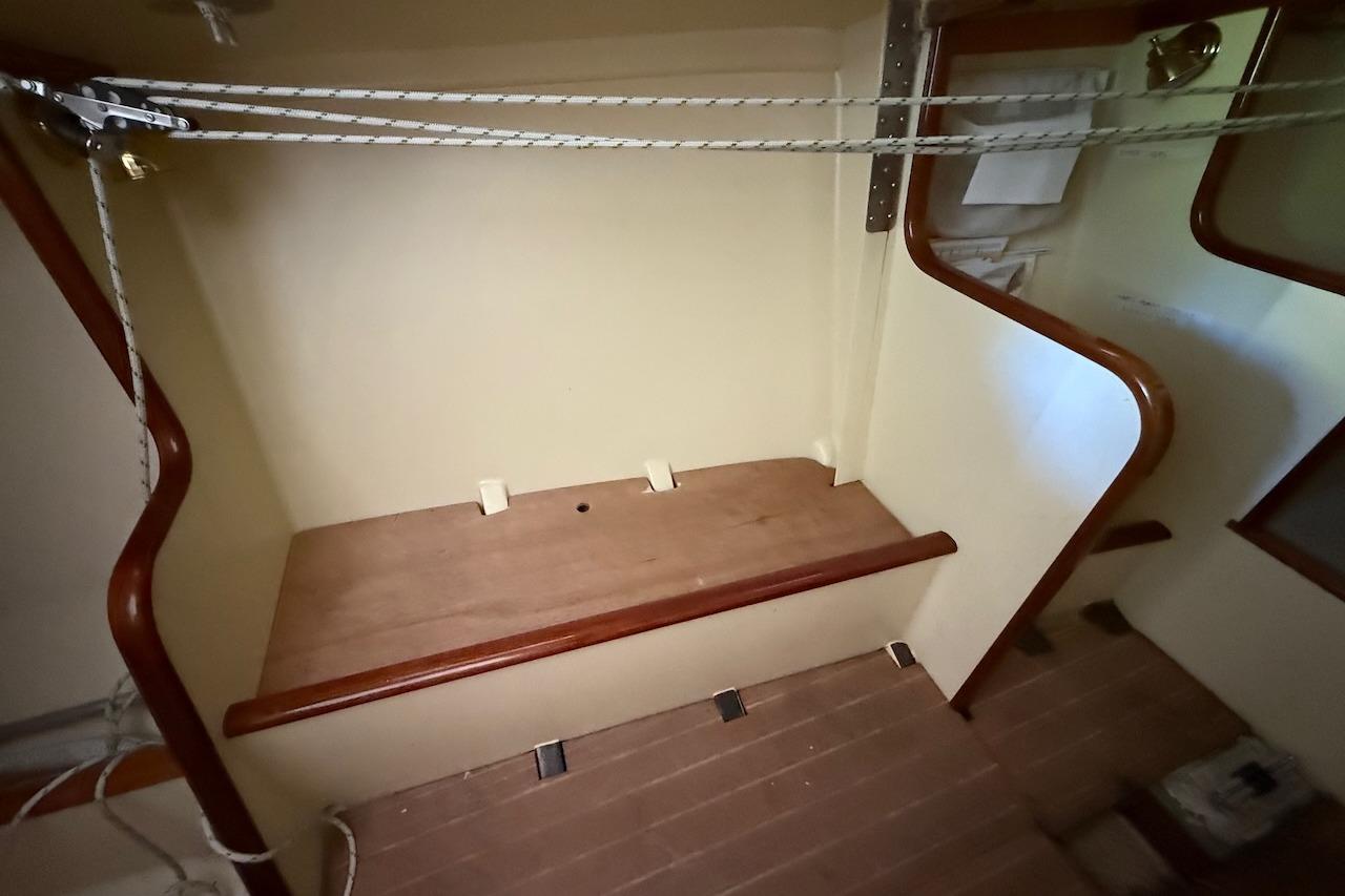 Interior of a 2007 Hallett 33 boat with wooden steps and rope details.