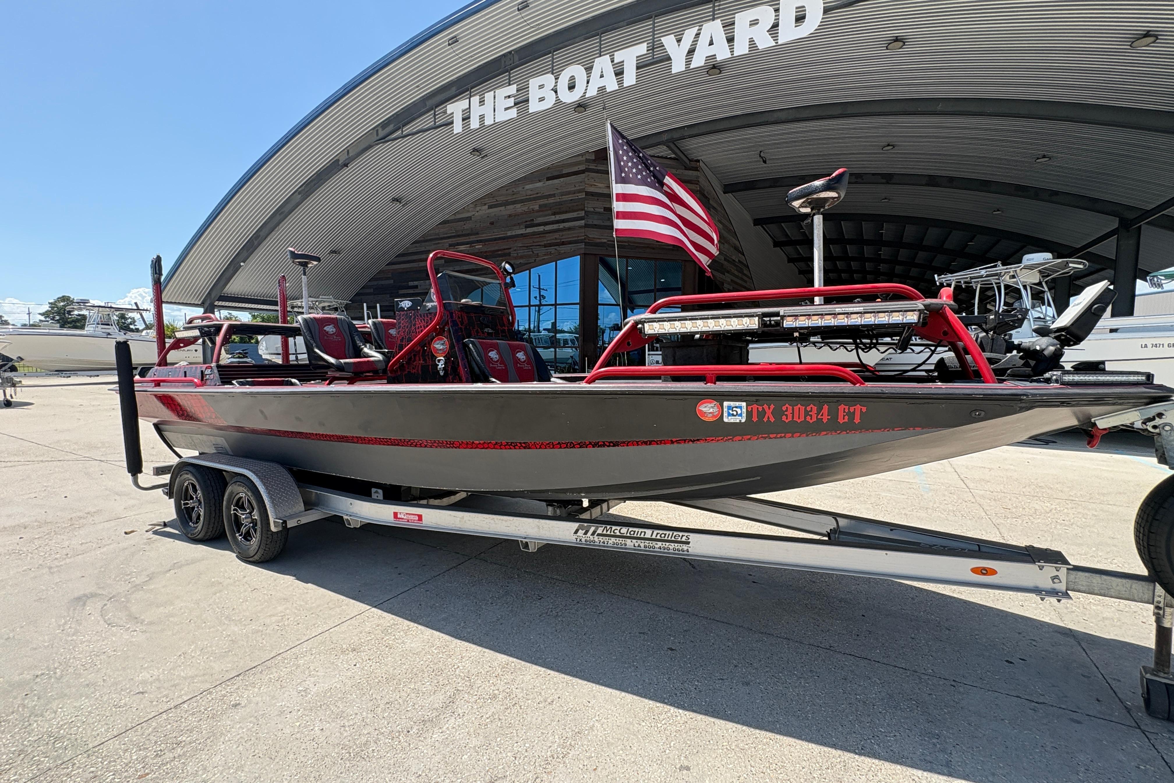 2018 Custom Swamp Shark 24' boat on trailer at The Boat Yard, American flag displayed.