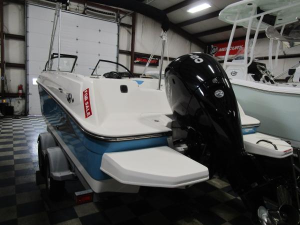 2023 Bayliner 210EL boat for sale in showroom, featuring sleek design and powerful engine.