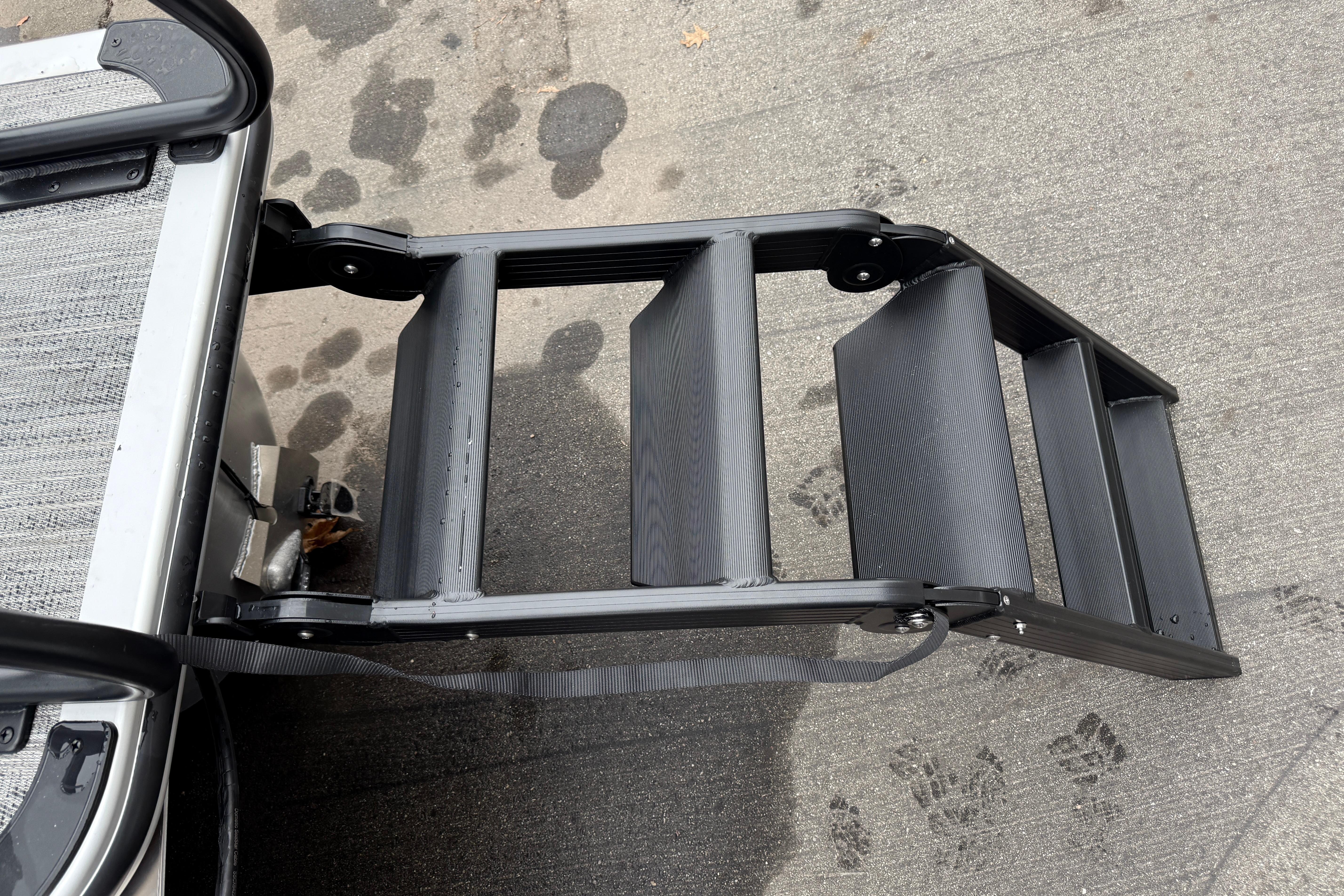 Bentley Pontoons Legacy 240 Navigator Ext 2026 boat ladder on concrete surface.