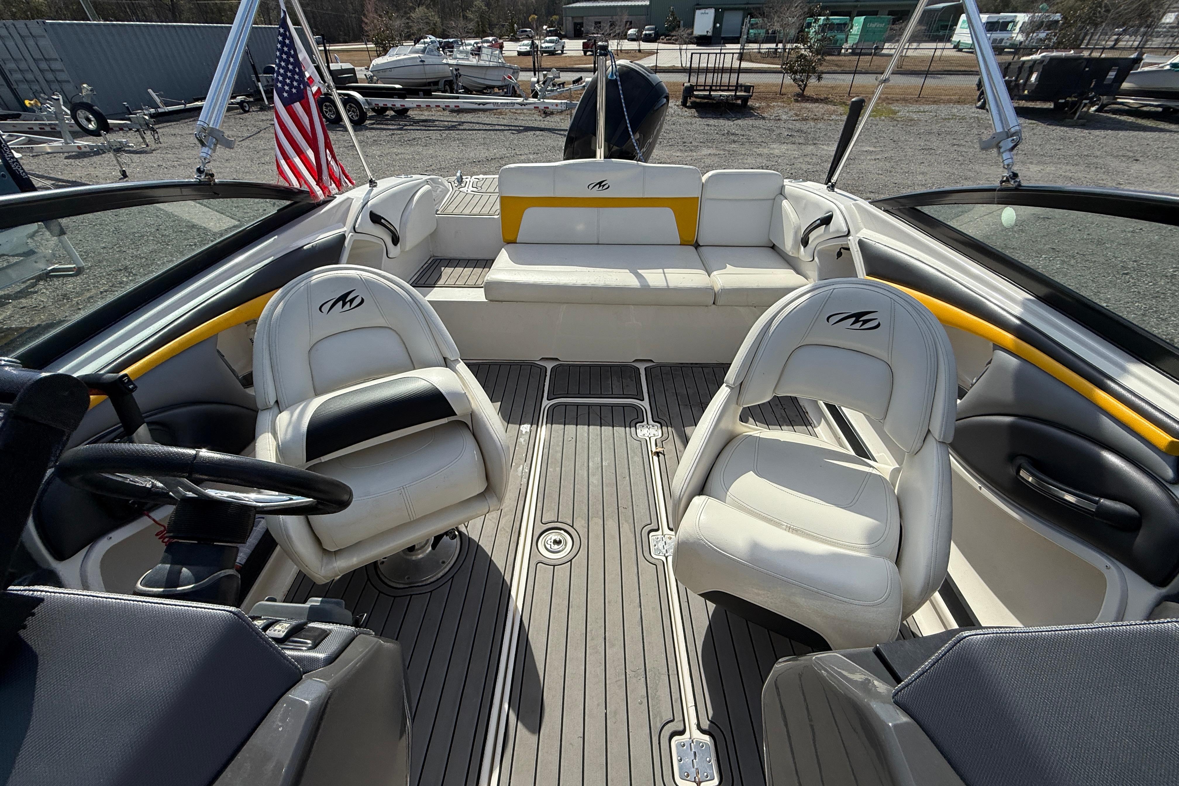 2014 Monterey 197 Blackfin boat interior with seating and steering wheel, docked outdoors.
