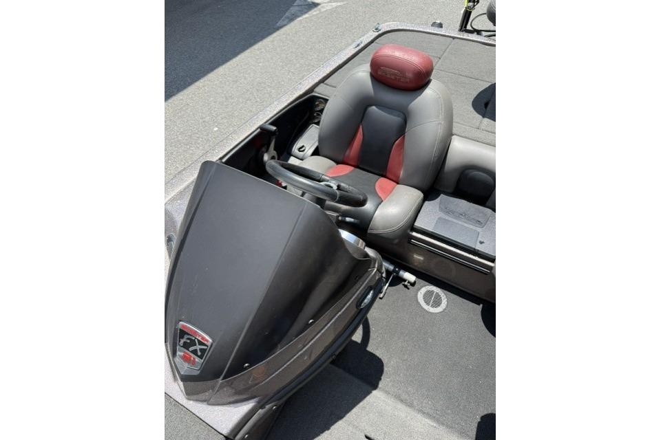 2013 Skeeter FX21 boat cockpit with steering wheel and cushioned seat.