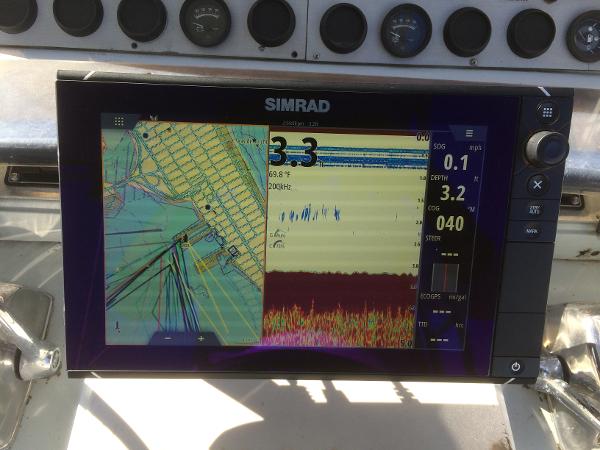 Simrad navigation display on 1987 Boston Whaler Cuddy Tower boat dashboard.