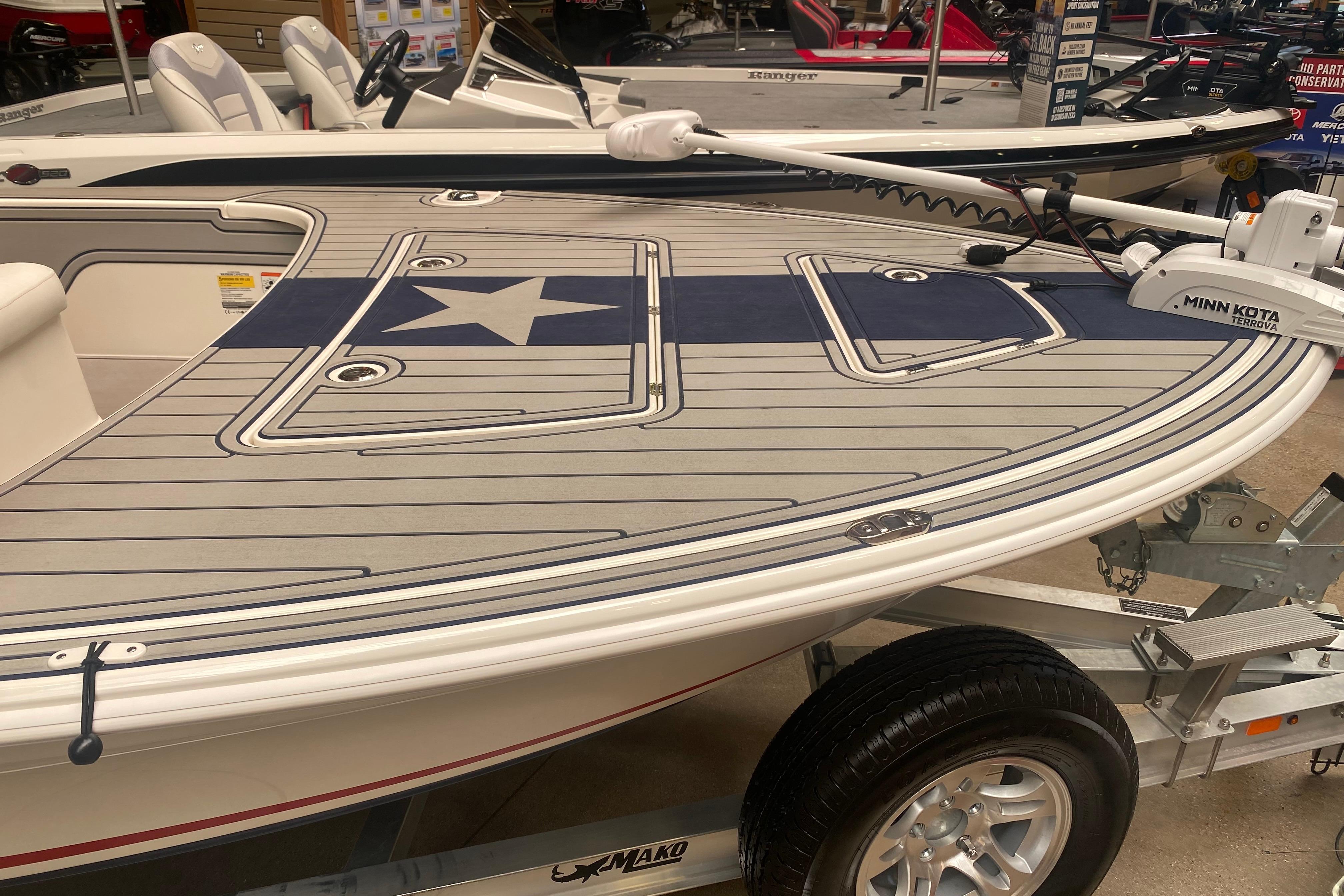 2025 Mako 18 Pro Skiff Patriot Edition boat with star design on deck.