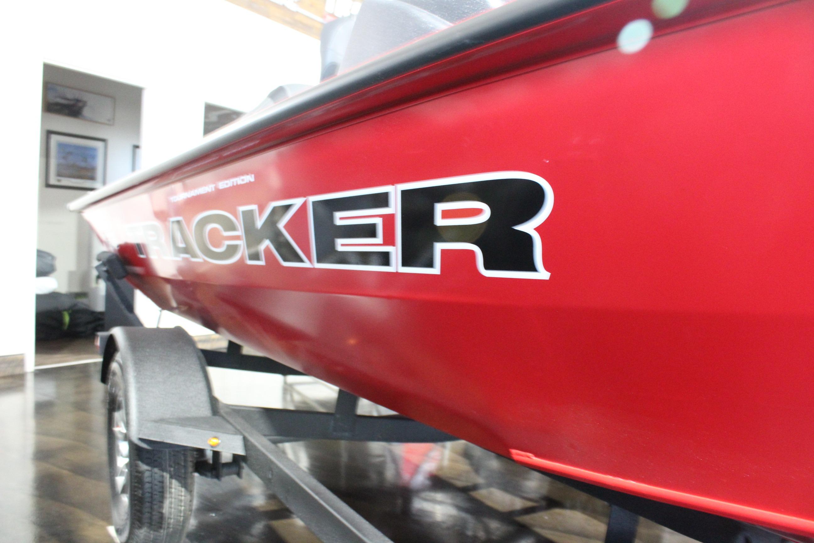 Red 2026 Tracker Pro Team 175 boat on trailer, close-up view.