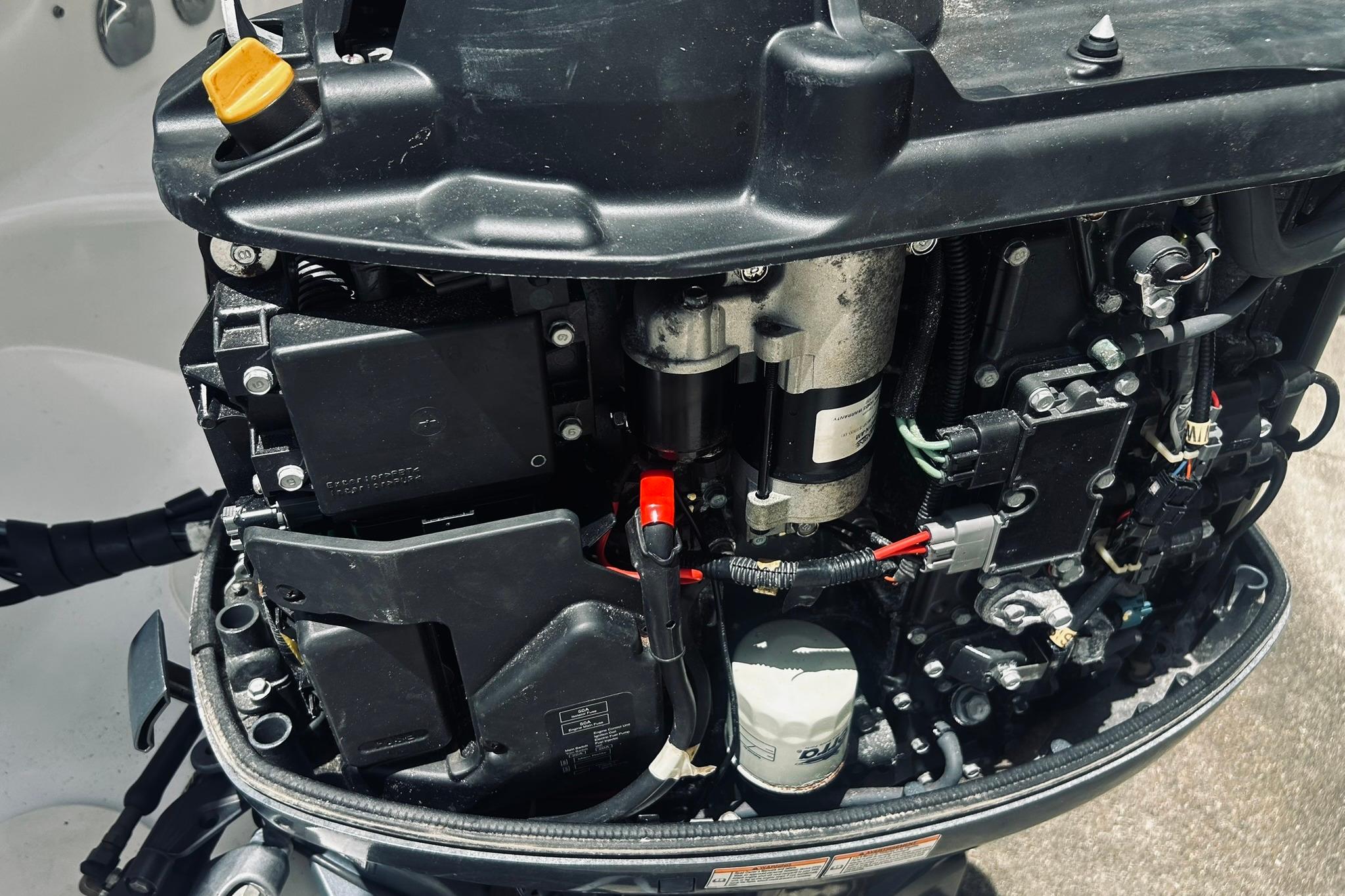 Close-up of a 2013 Hurricane SunDeck Sport 201 OB boat engine components.