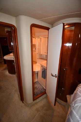 Interior of 2003 Sea Ray 460 Sundancer yacht, featuring a bathroom and wooden cabinetry.