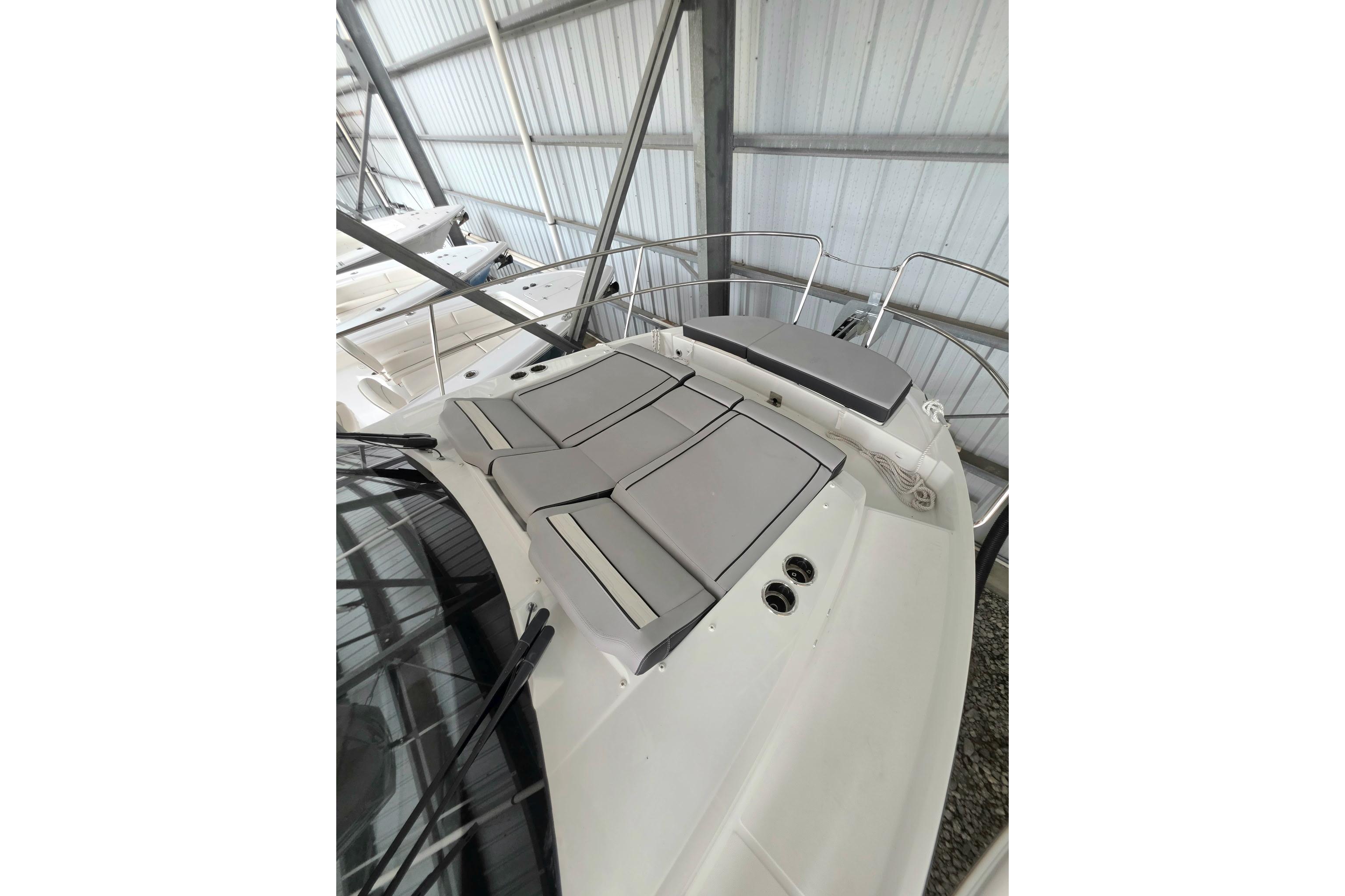 2026 Jeanneau NC 895 Series 2 boat with cushioned deck in a storage facility.