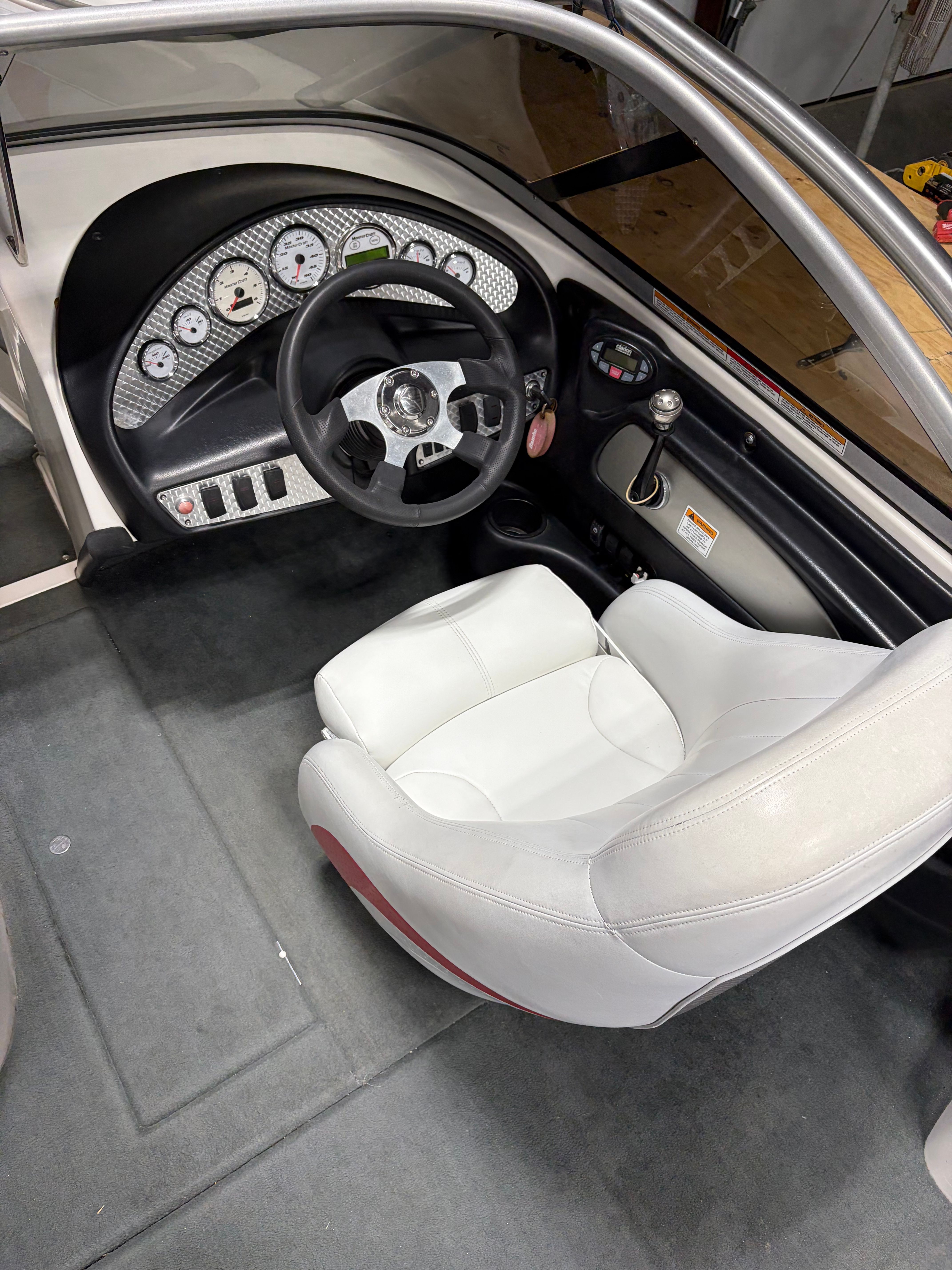 Interior of a 2004 MasterCraft X2 boat with steering wheel and seat.