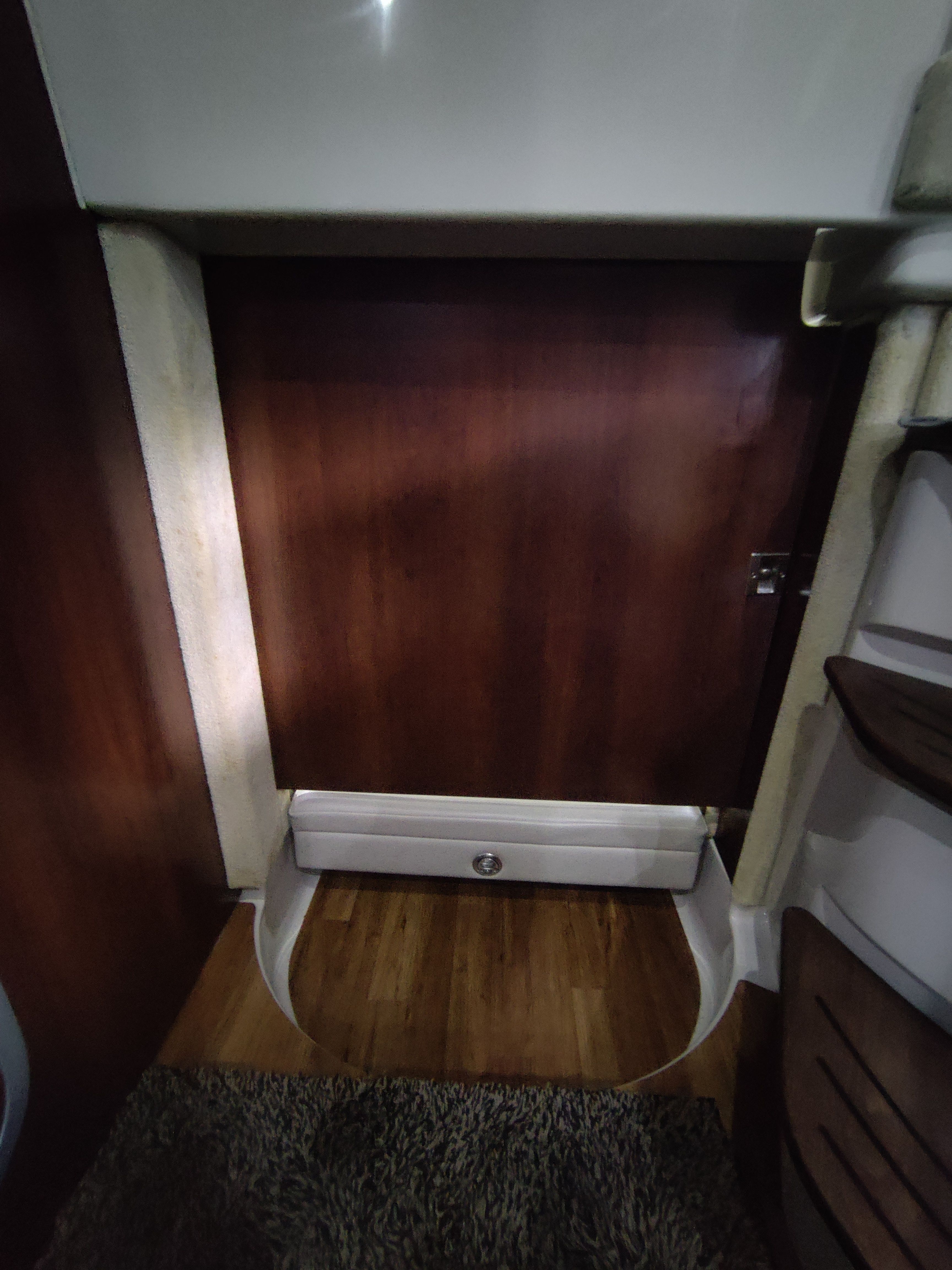 Interior of 2014 Chaparral 330 Signature with wooden door and carpet.