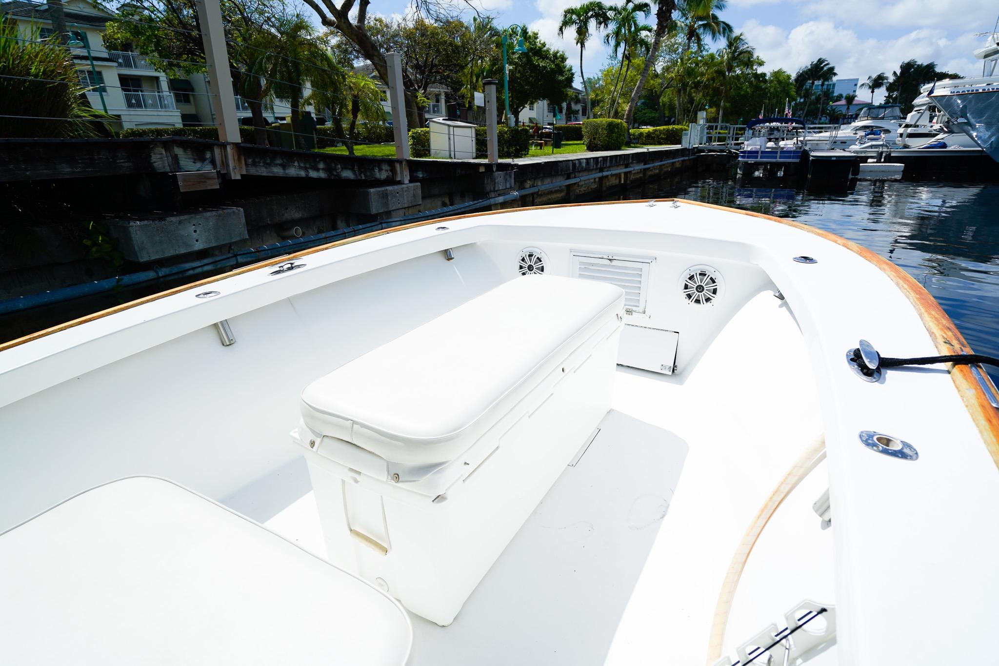 1977 Scarborough 27 CC boat interior with white seating, docked near palm trees.