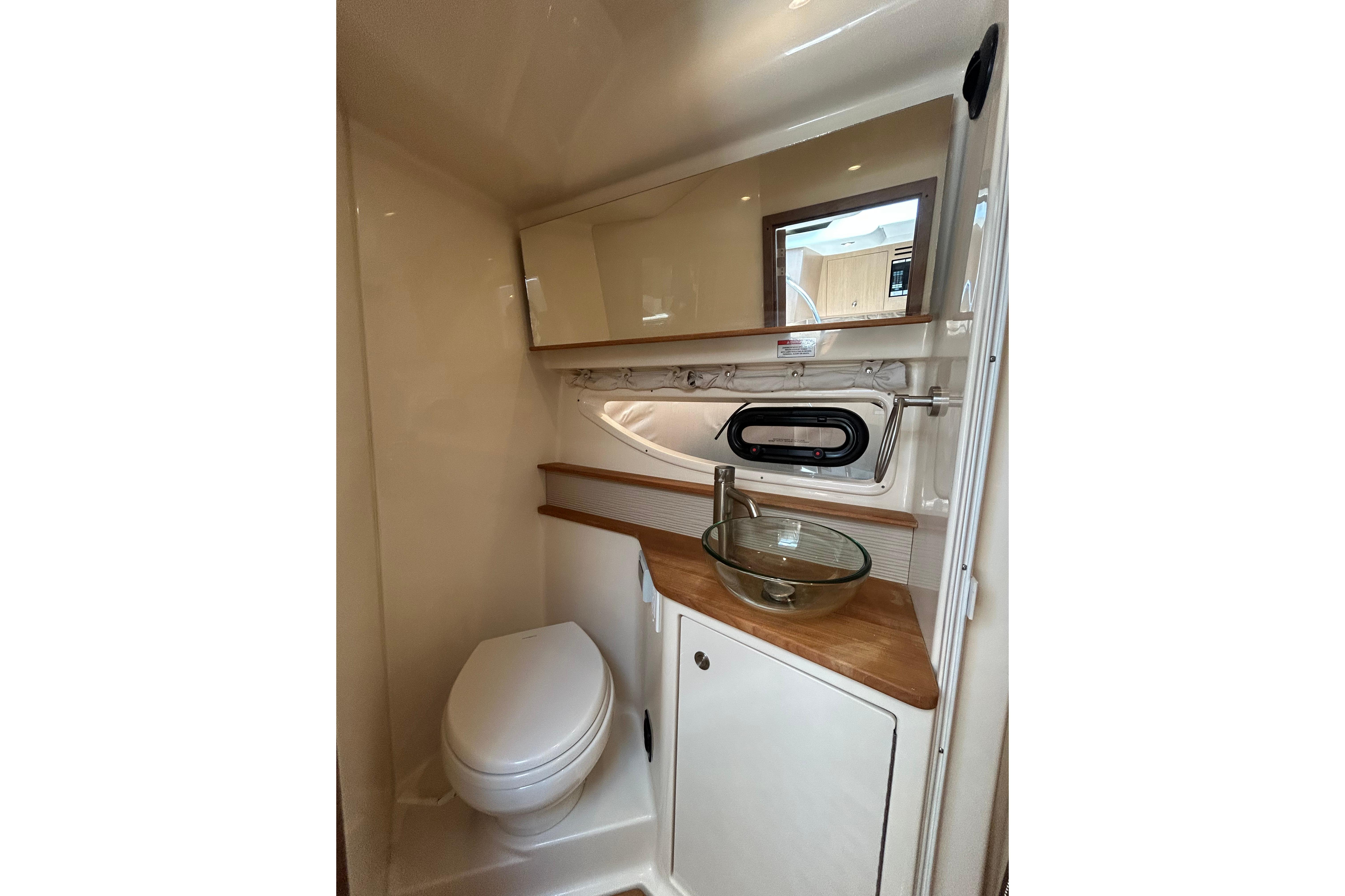 2019 Sea Ray Sundancer 350 bathroom with modern fixtures, glass sink, and compact design.