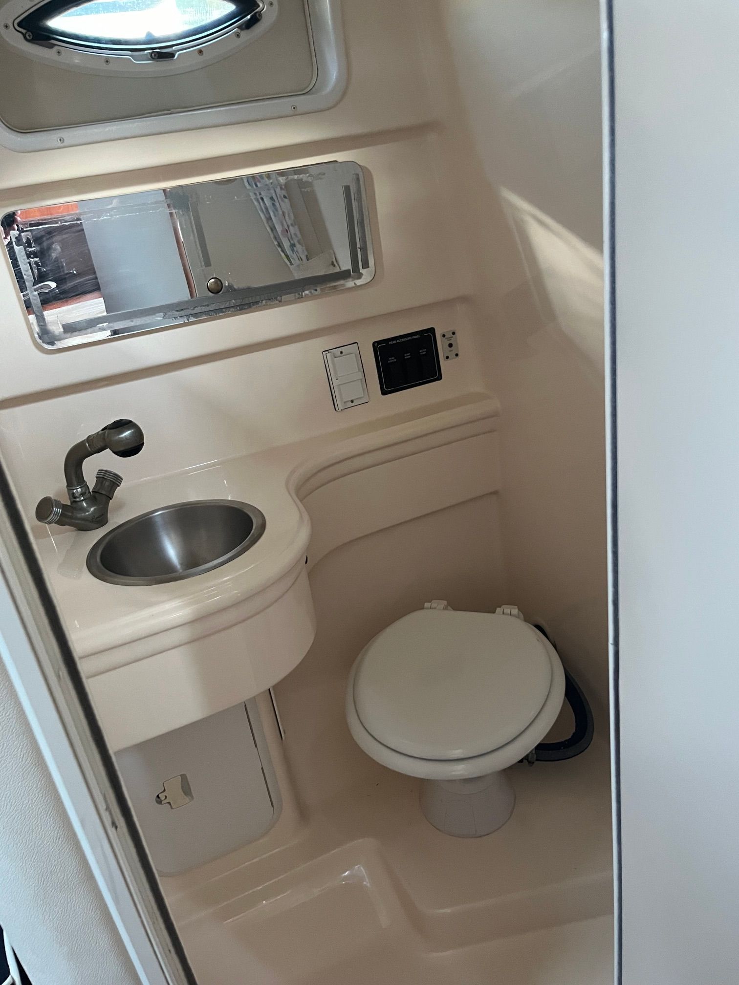 Interior of a 2004 Larson Cabriole with sink and toilet.