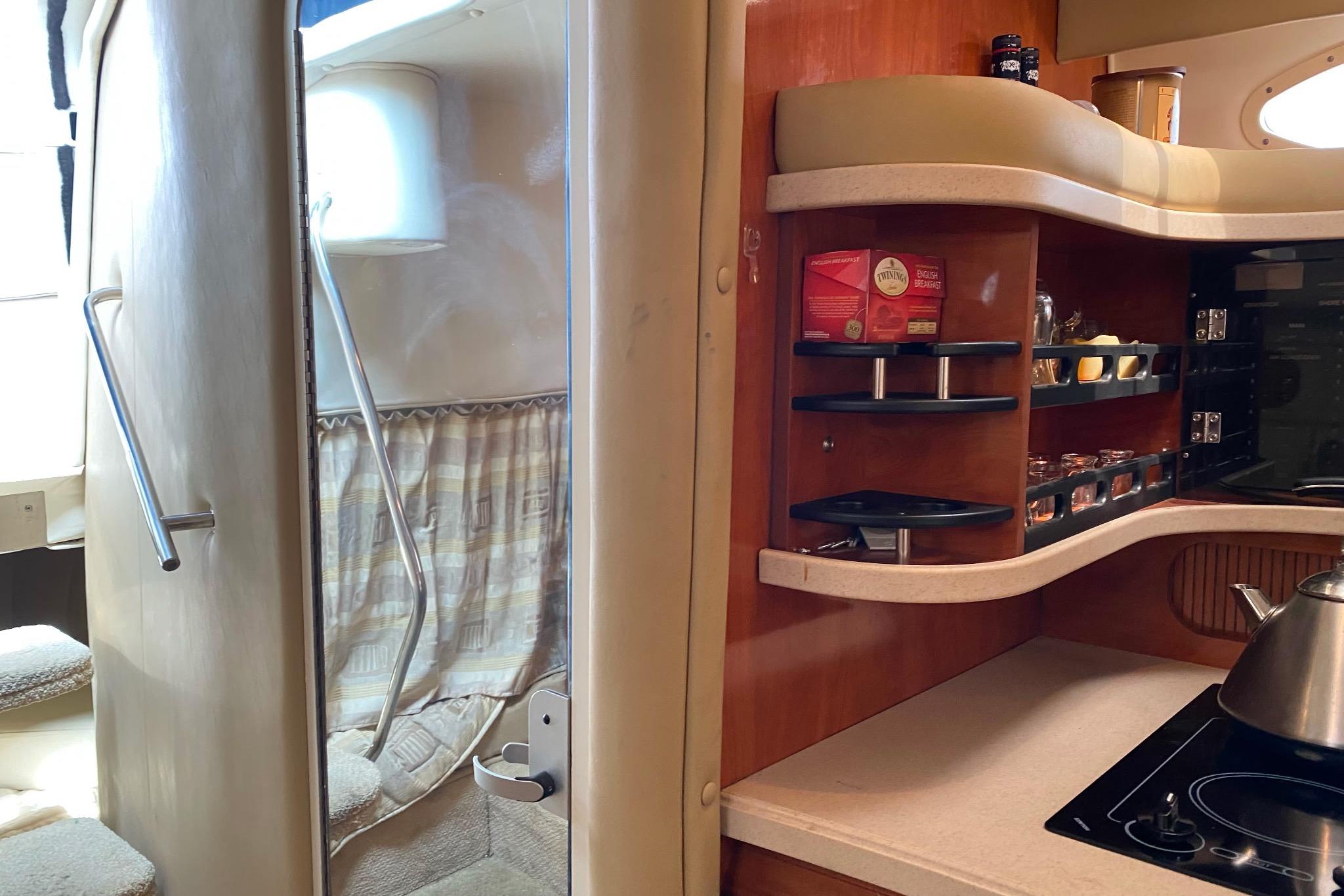 Interior of 2003 Rinker Fiesta Vee 342 yacht with kitchenette and cozy cabin space.