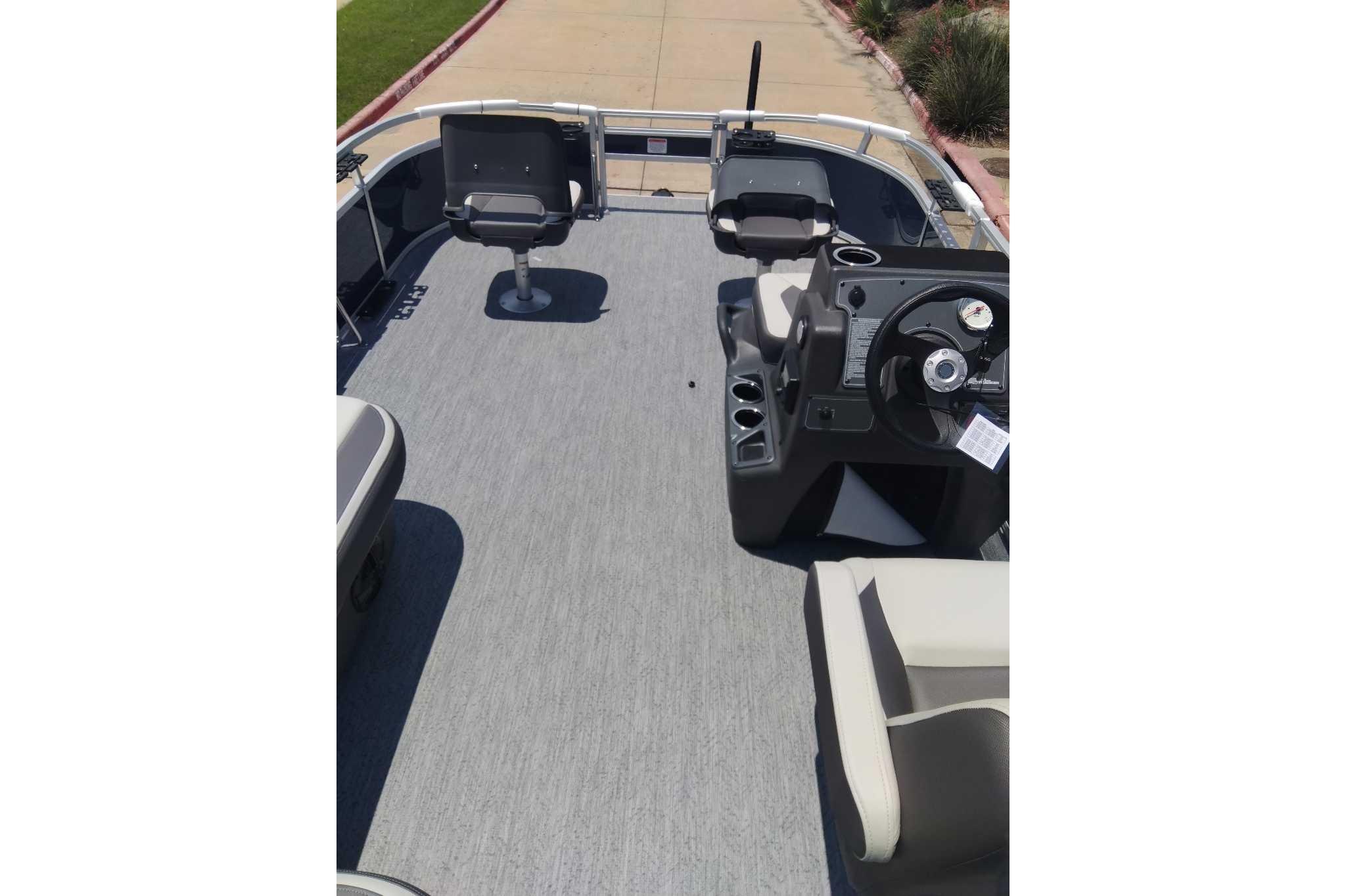 2026 Sun Tracker Bass Buggy 16 XL Select pontoon boat interior with seating and steering console.