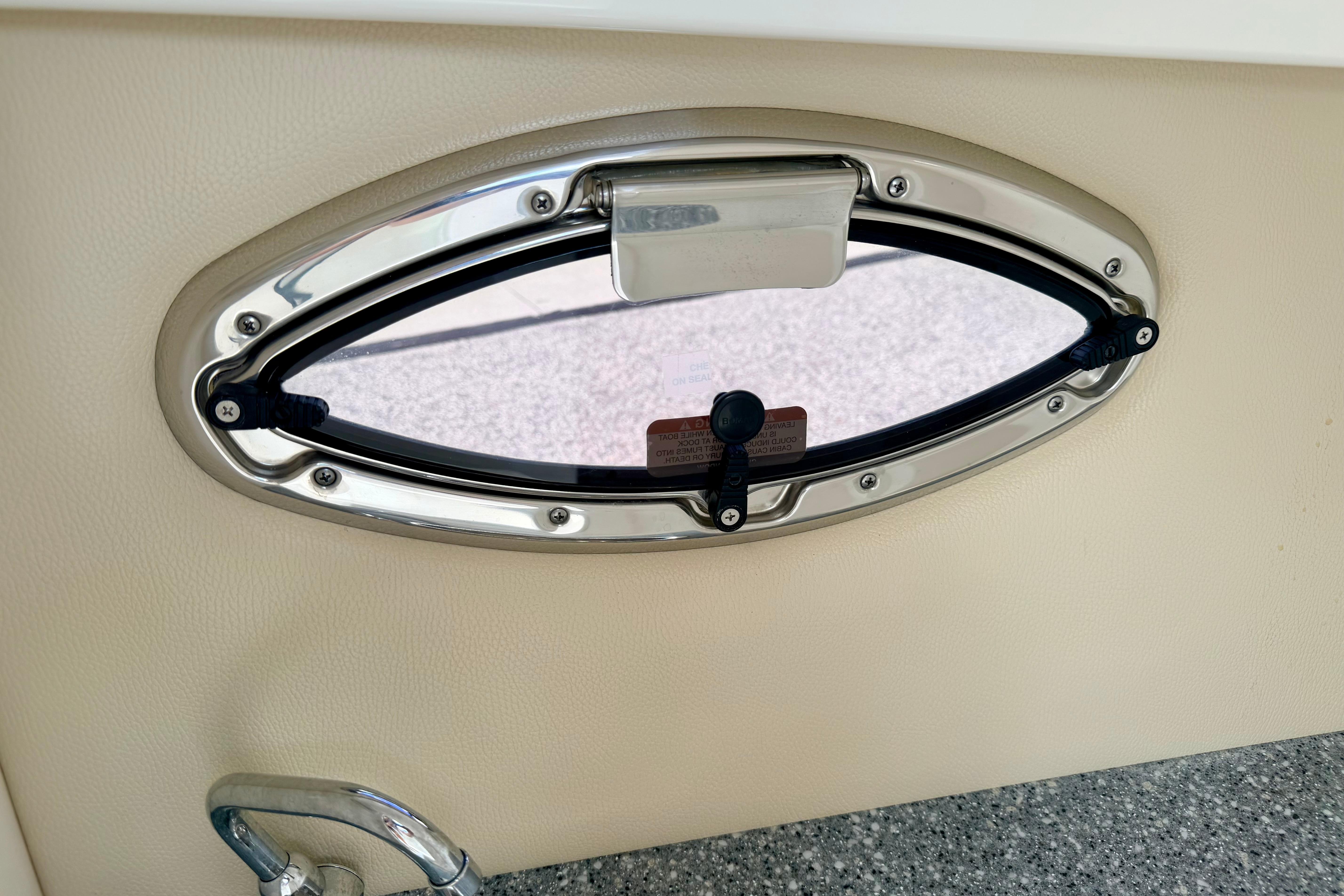Oval window on 2015 Chaparral Sunesta 264 boat interior.