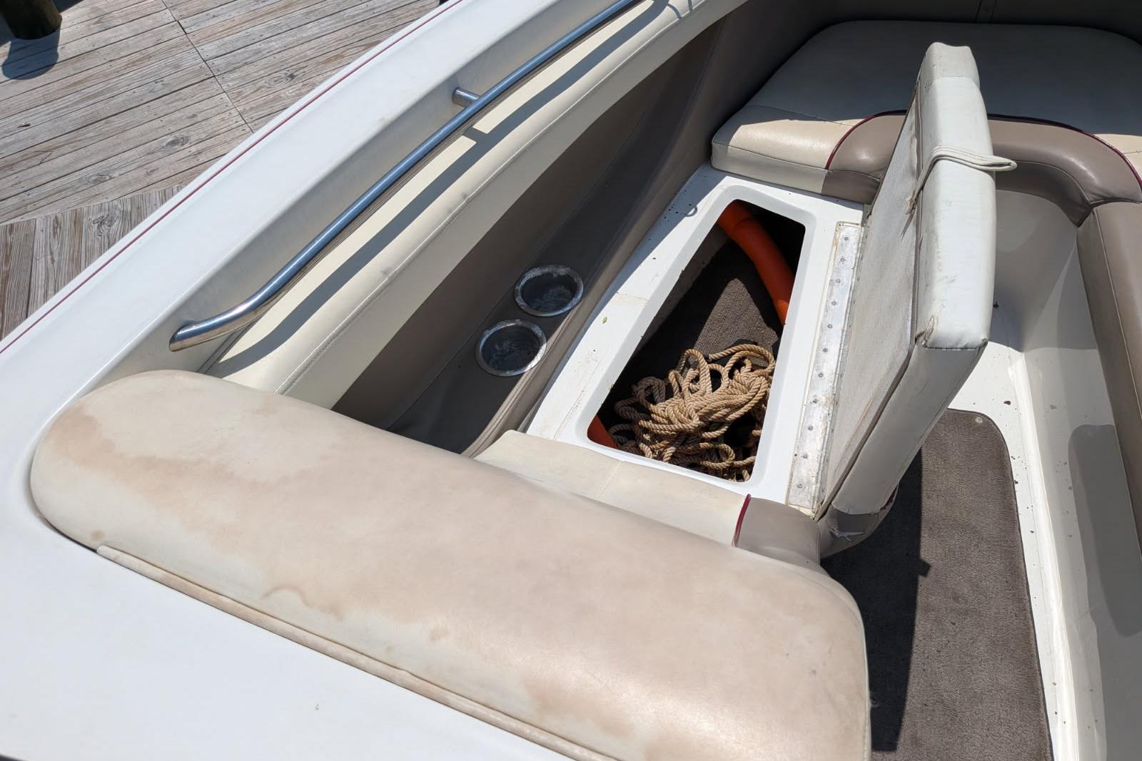 Interior of a 2020 Cobalt 206 boat showing seating and storage compartment with rope.