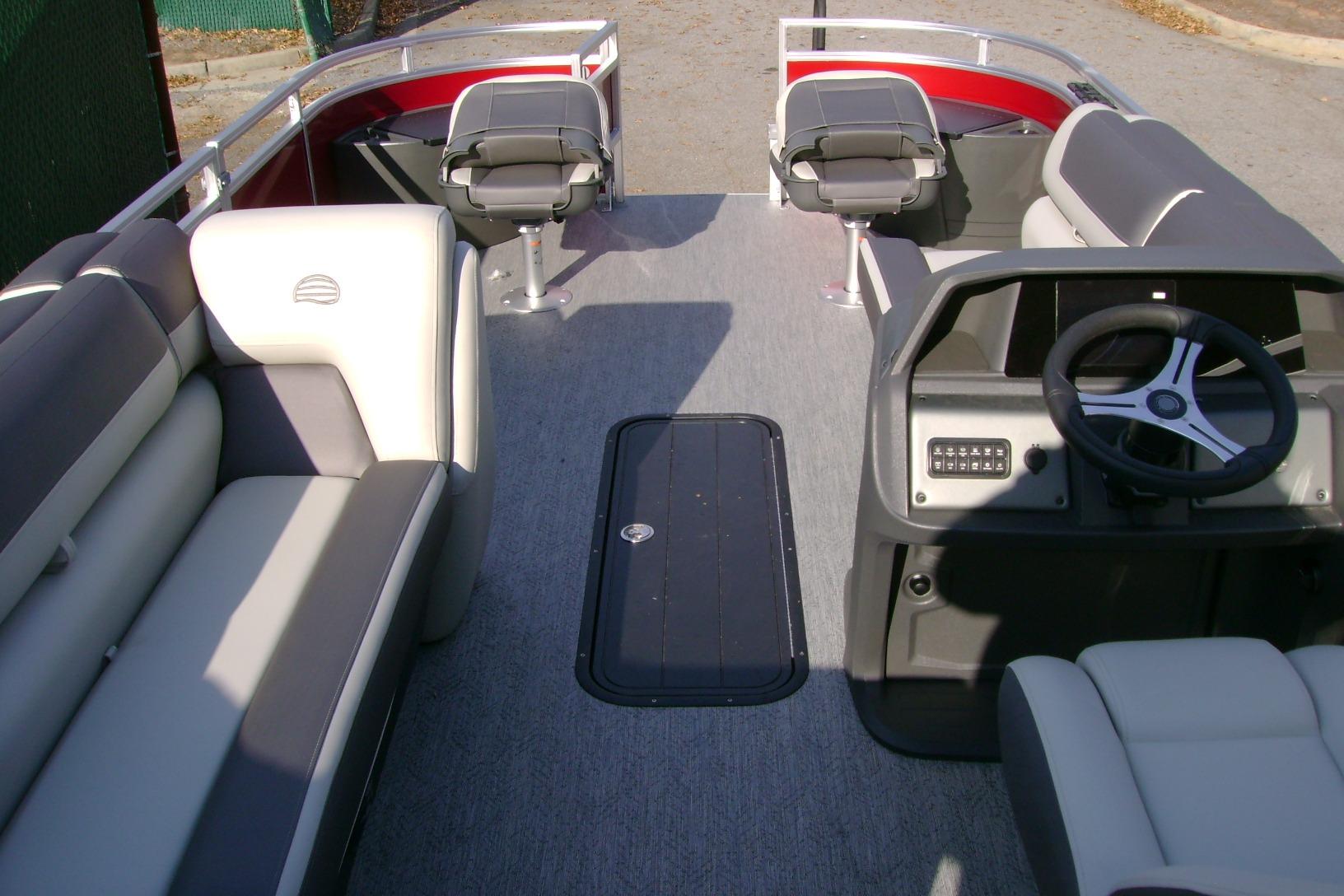 2026 Sun Tracker Fishin' Barge 22 XP3 interior with seating and steering console.