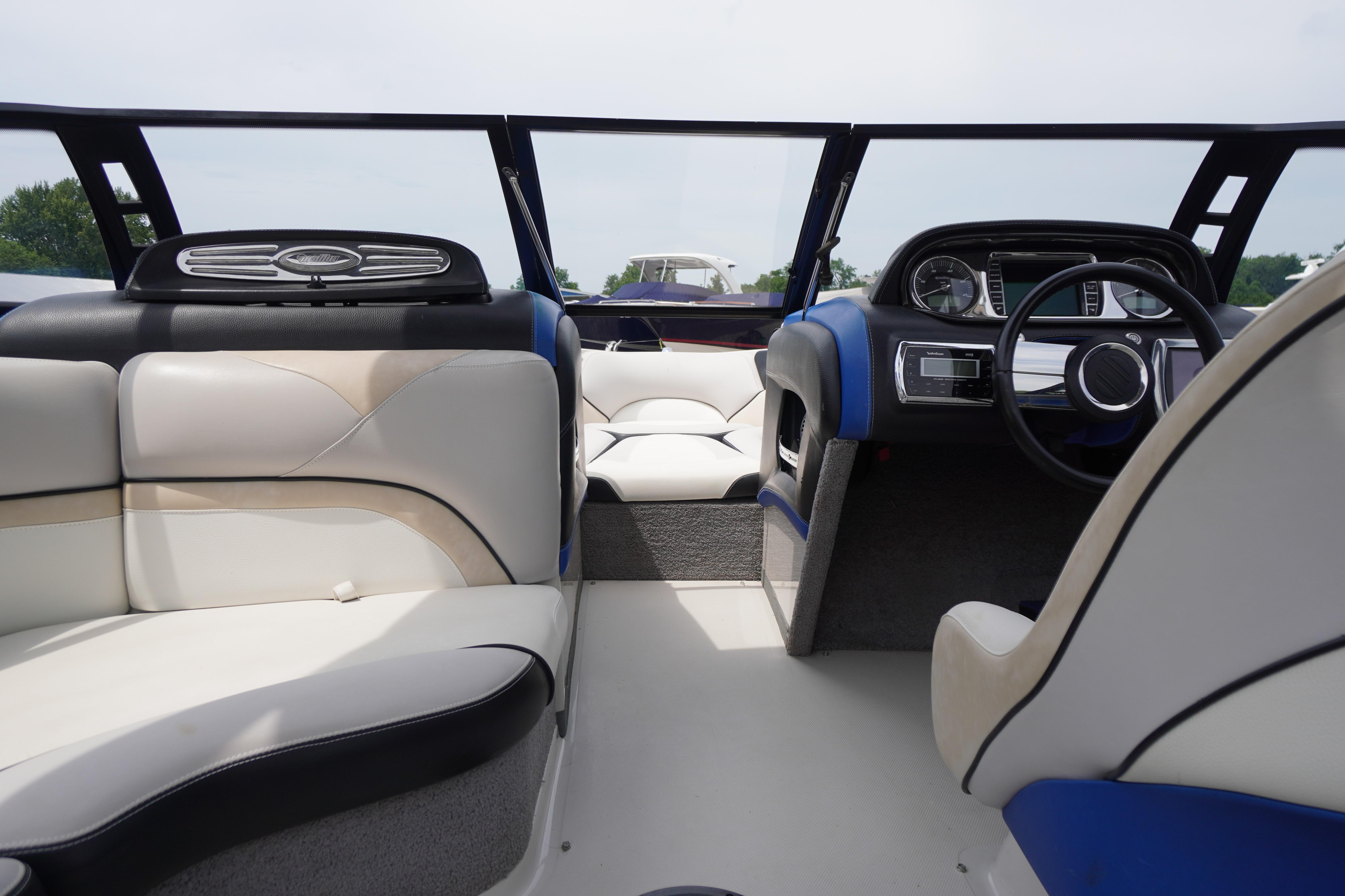 Interior of 2011 Malibu Wakesetter 21 VLX boat, featuring sleek seating and modern dashboard.
