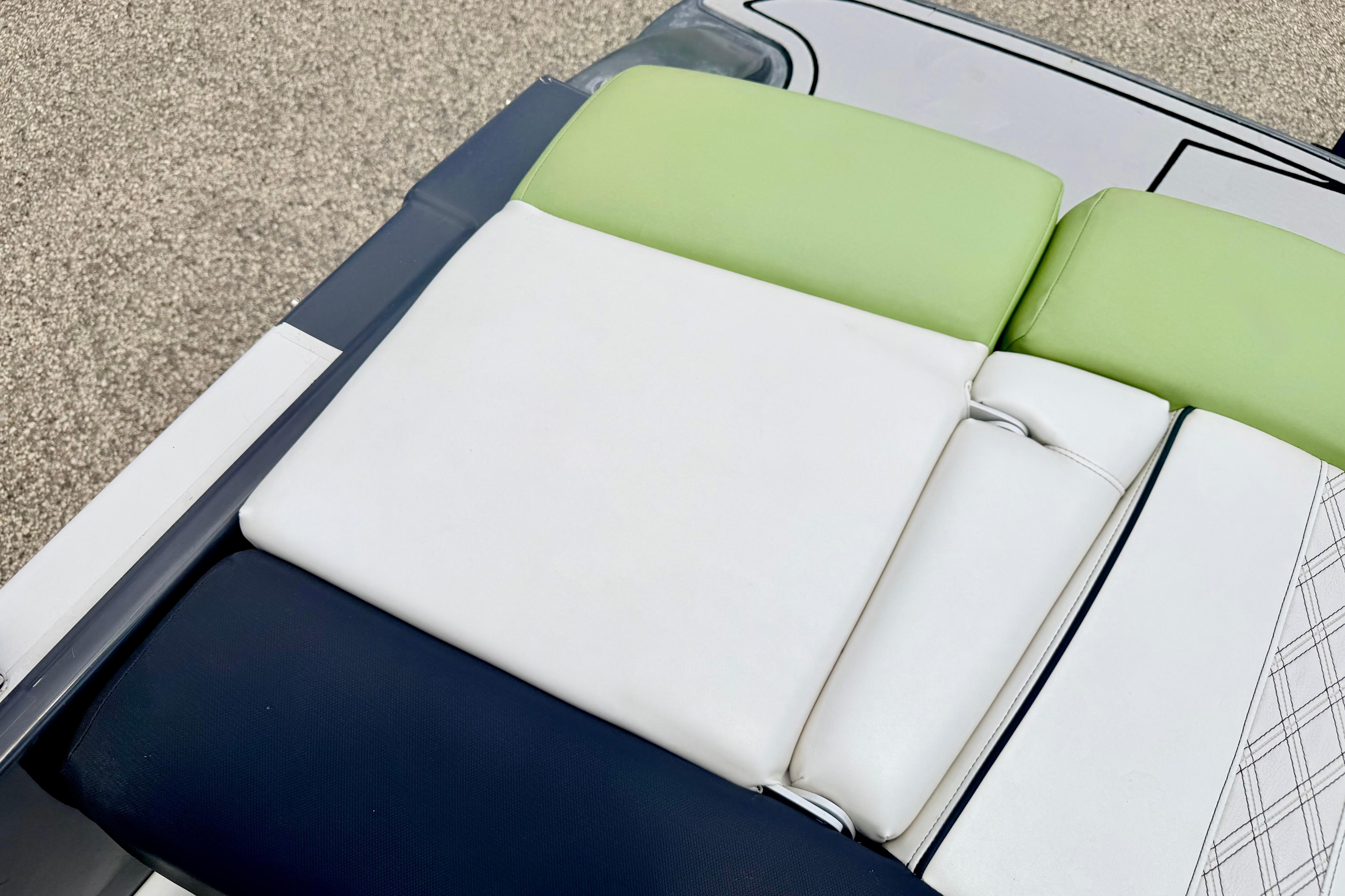 2018 Glastron GT 185 boat seat with green, white, and navy upholstery.
