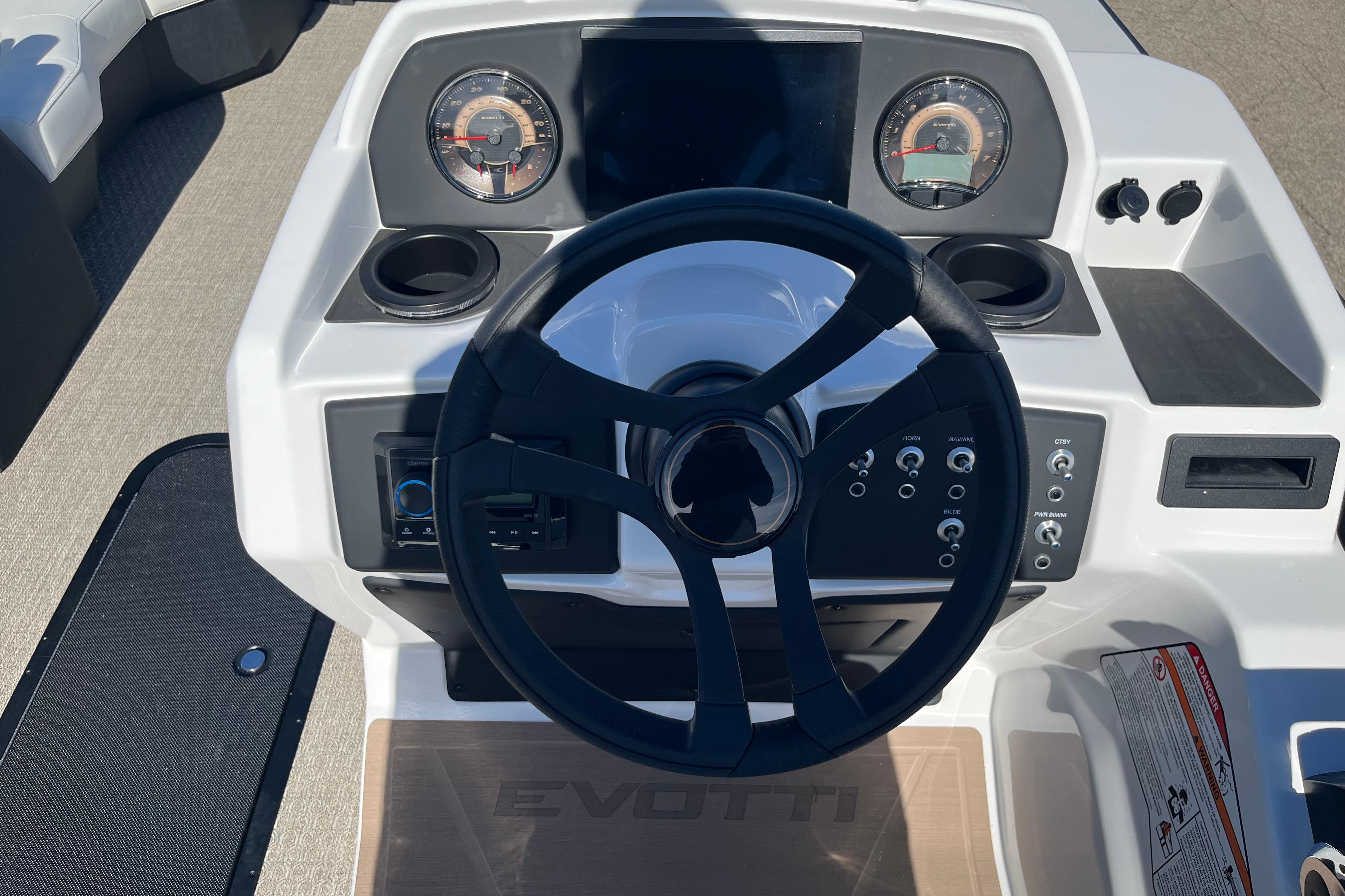 Steering console of 2026 Evotti 523CS boat with modern controls and gauges.