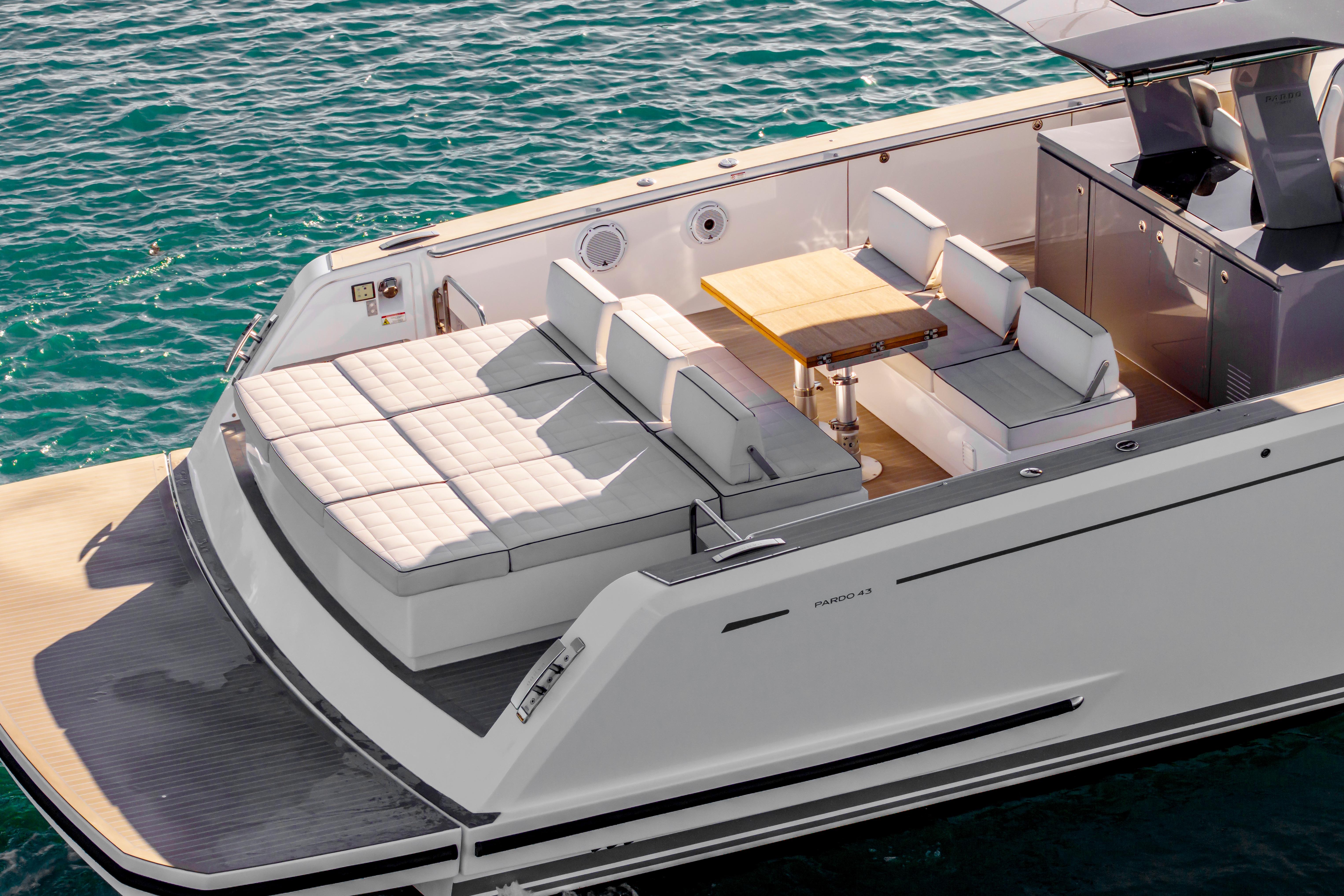 2024 Pardo Yachts P43 luxury deck with seating and table on calm water.