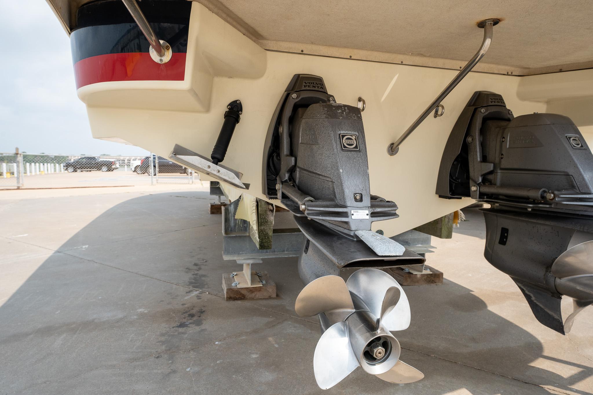 2013 Chris-Craft Launch 32 boat propellers and stern view on a trailer.