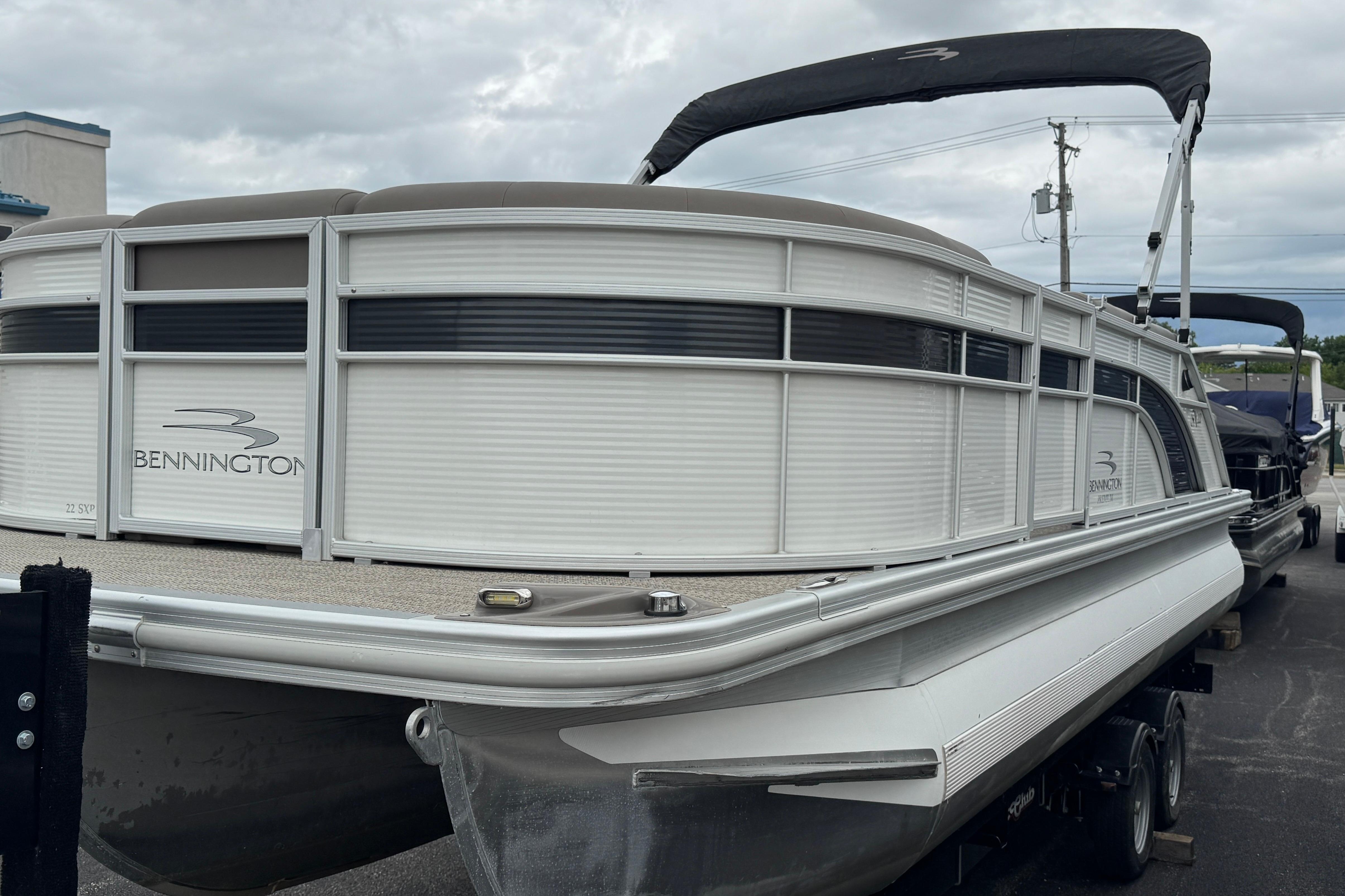 2019 Bennington SX 22 SSBXP pontoon boat with canopy, parked on a trailer.
