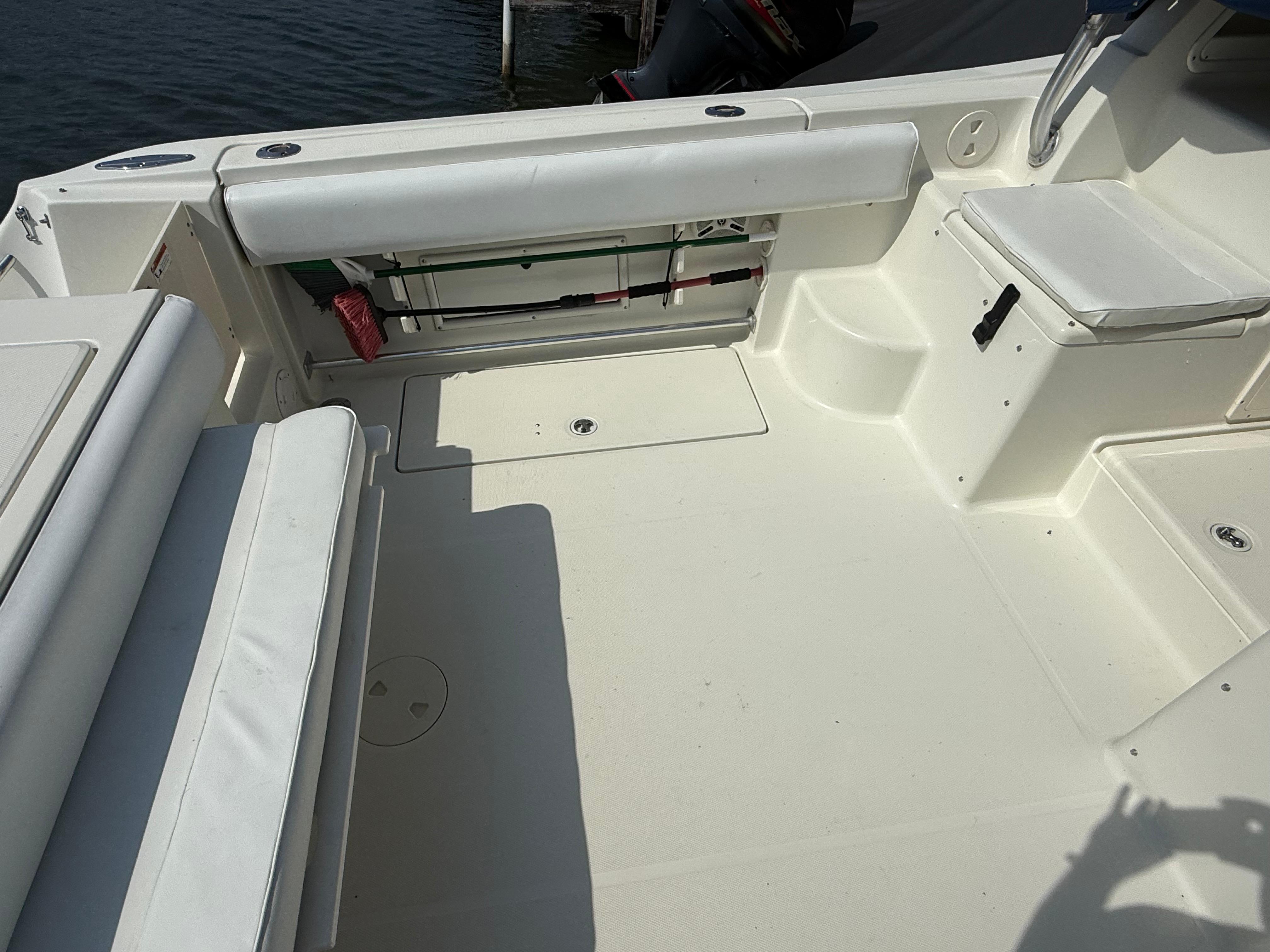 2003 Hydra-Sports Vector 2800 WA boat interior with white seating and storage compartments.