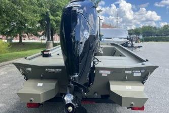 2026 Tracker Grizzly 1860 CC boat with outboard motor, parked outdoors.