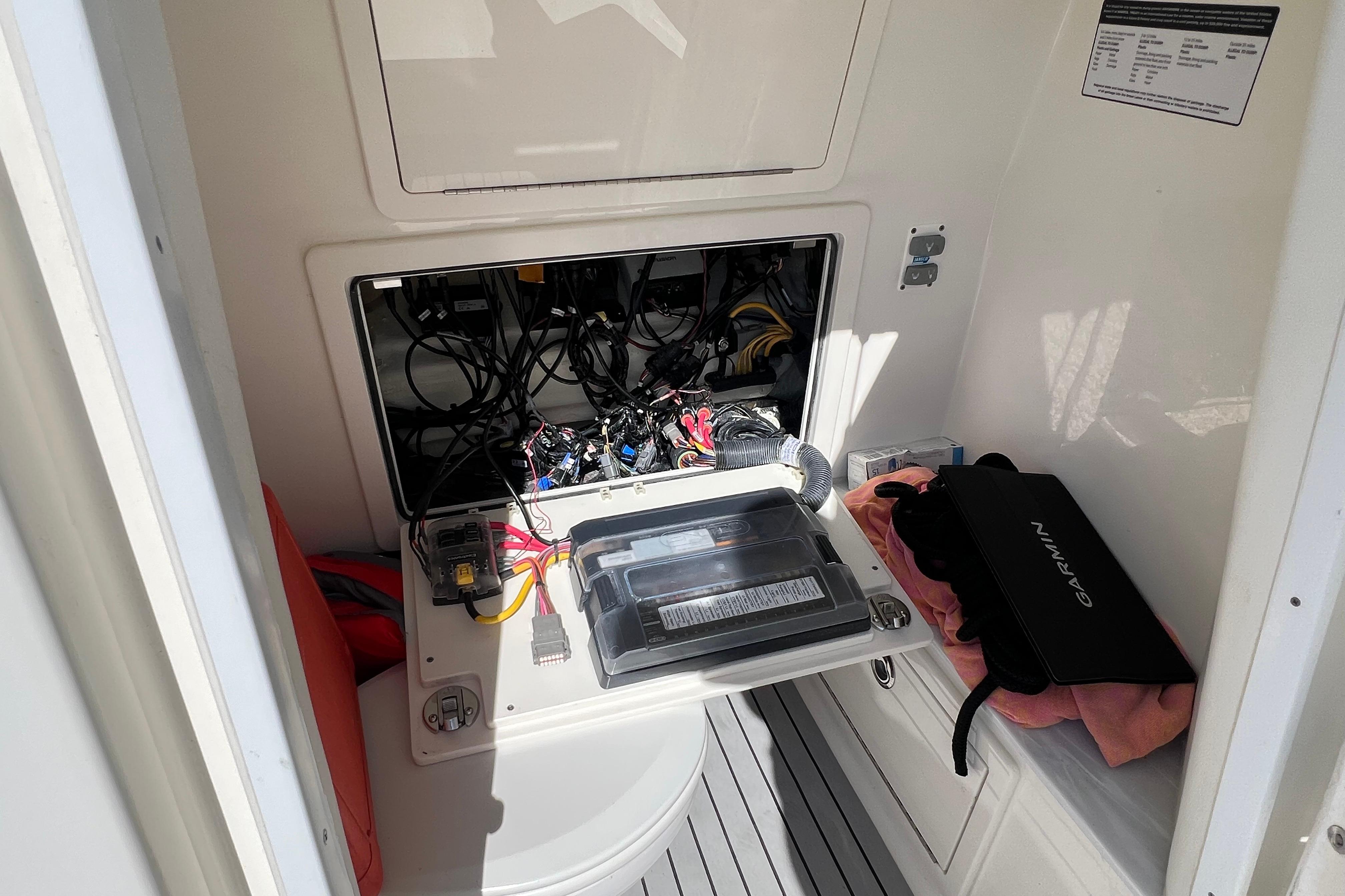 2022 World Cat 280 CC-X electrical compartment with wiring and Garmin equipment.