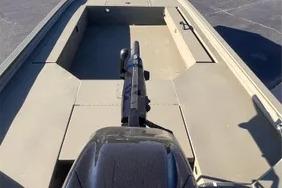 2026 Tracker Grizzly 1654 T Sportsman boat, interior view with motor, on a sunny day.