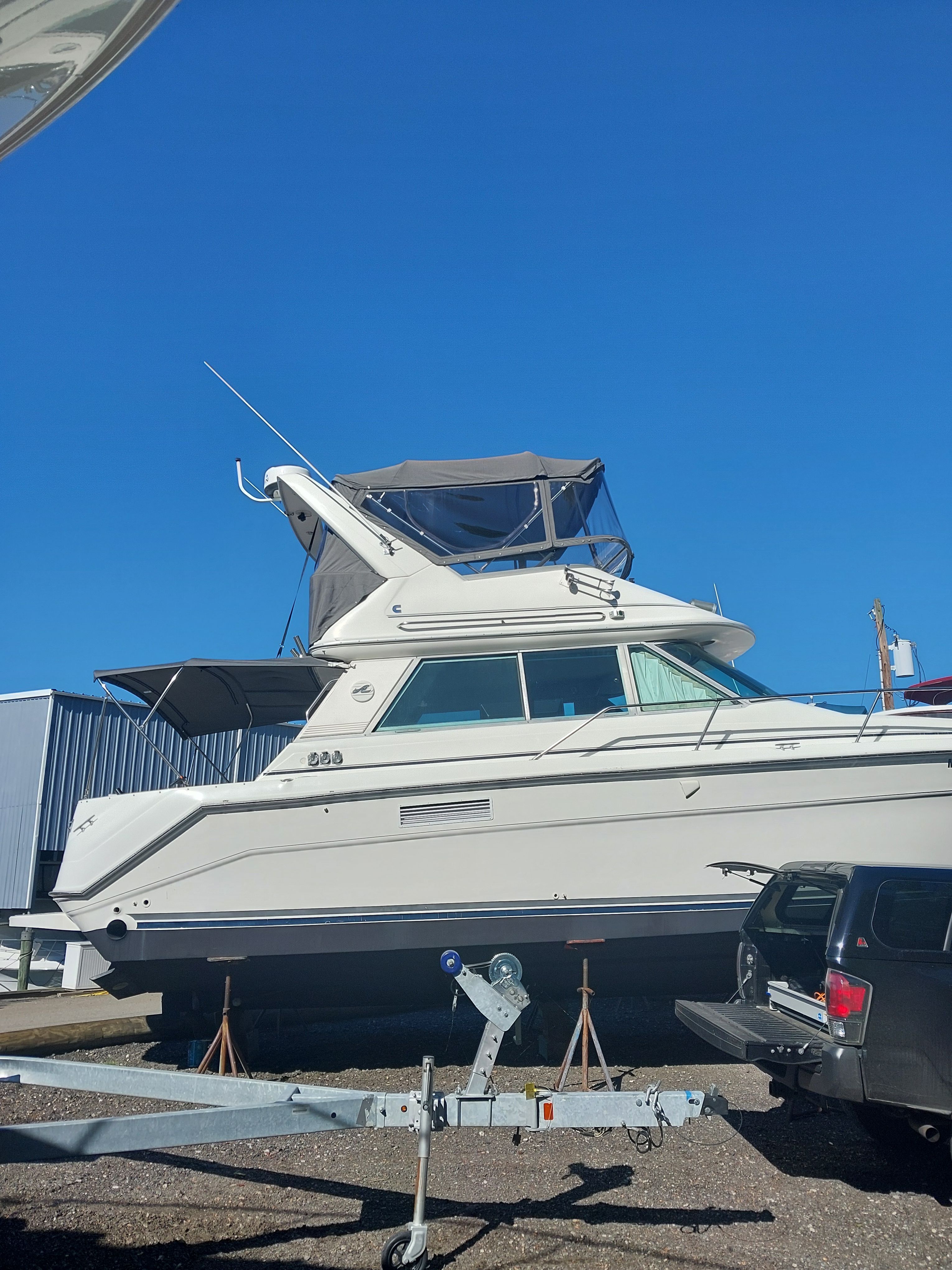 1991 Sea Ray 370 Sedan Bridge on a trailer outdoors.