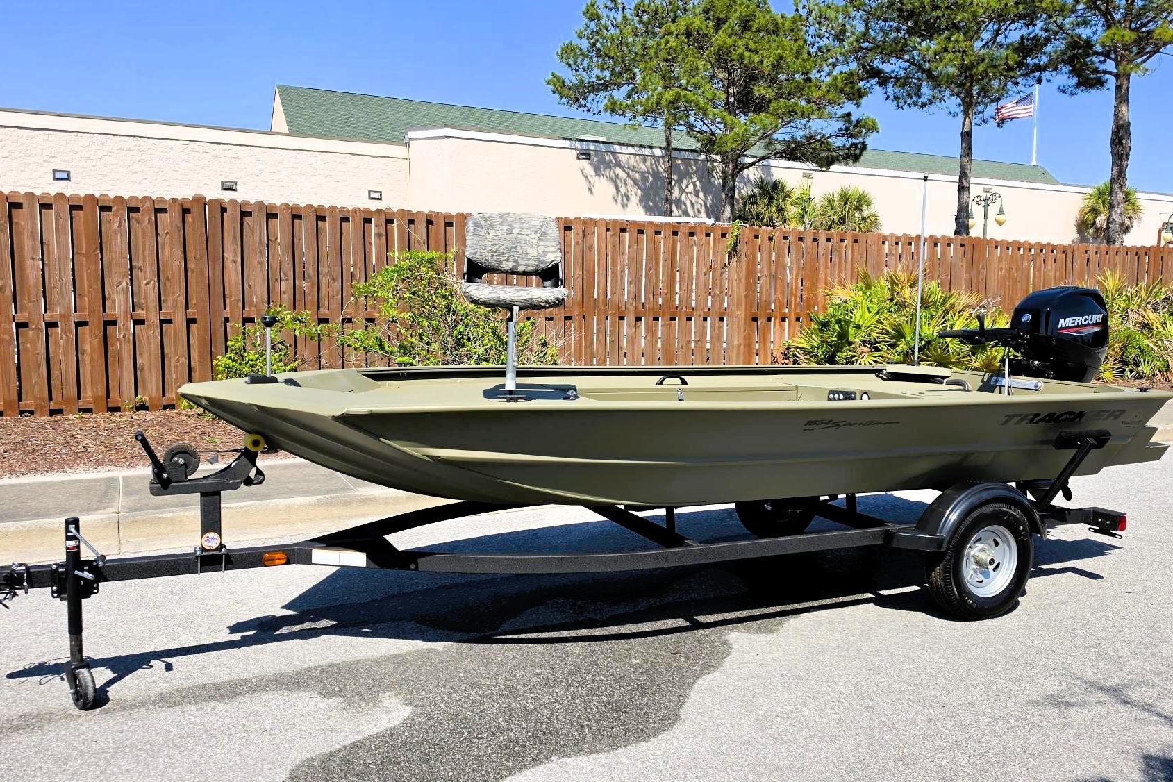 2026 Tracker Grizzly 1654 T Sportsman boat on trailer, parked outdoors.