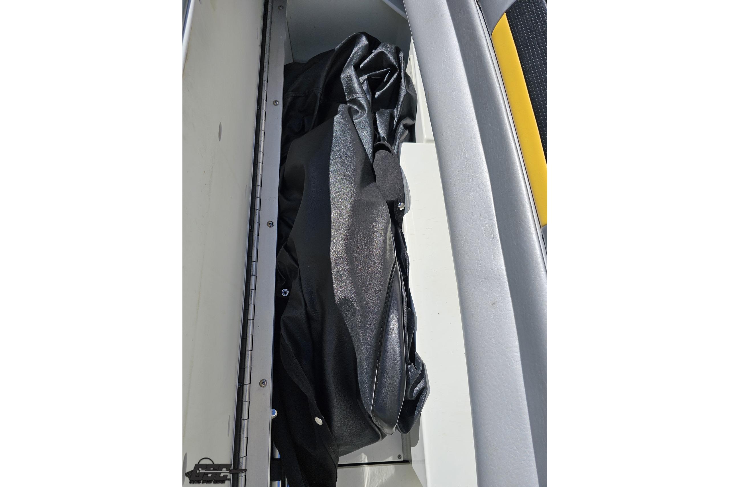 Storage compartment in a 2014 Formula 292 FASTech boat, featuring a black cover.
