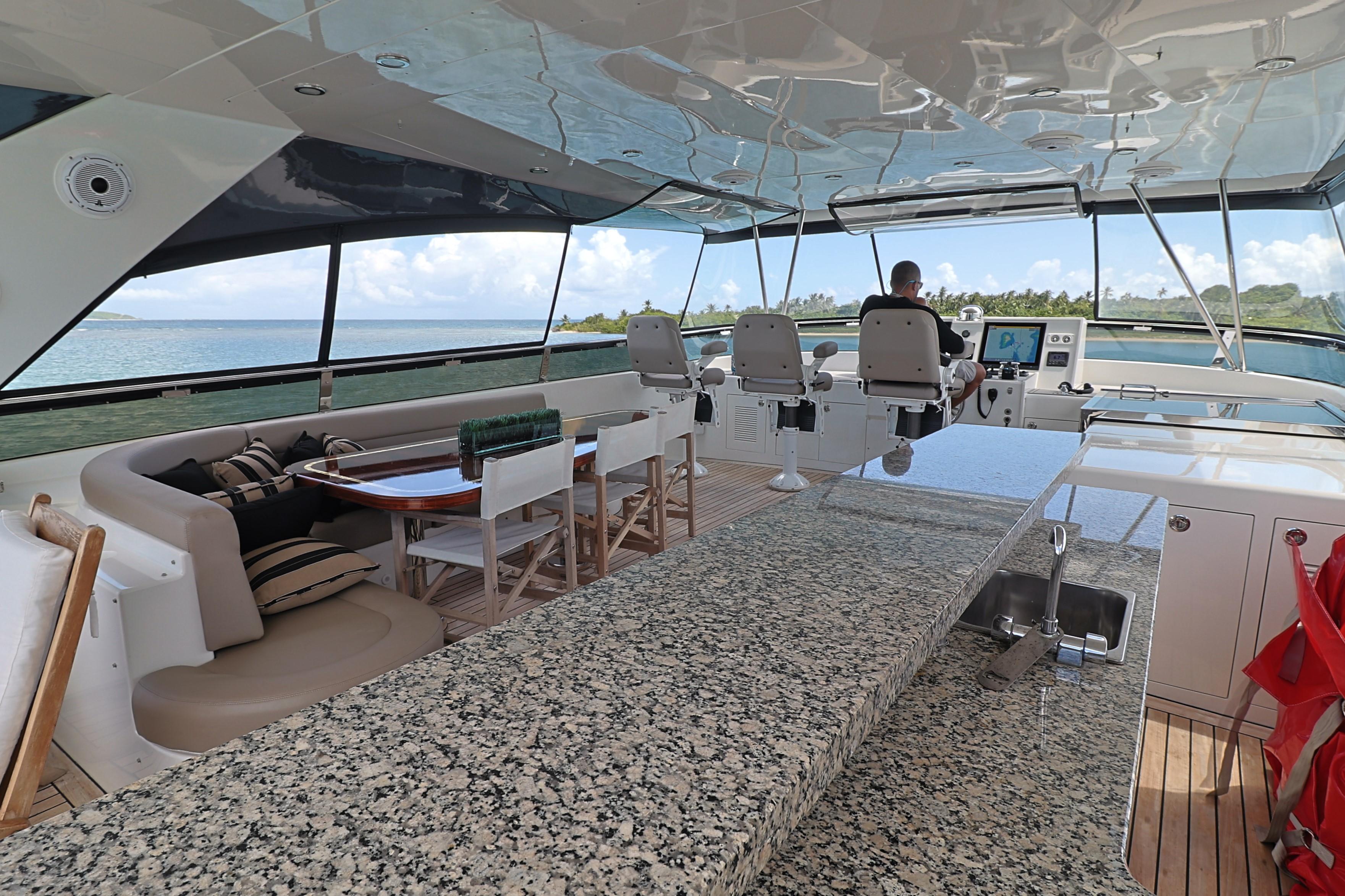 Luxurious 2013 Cheoy Lee Bravo yacht interior with granite countertop and ocean view.