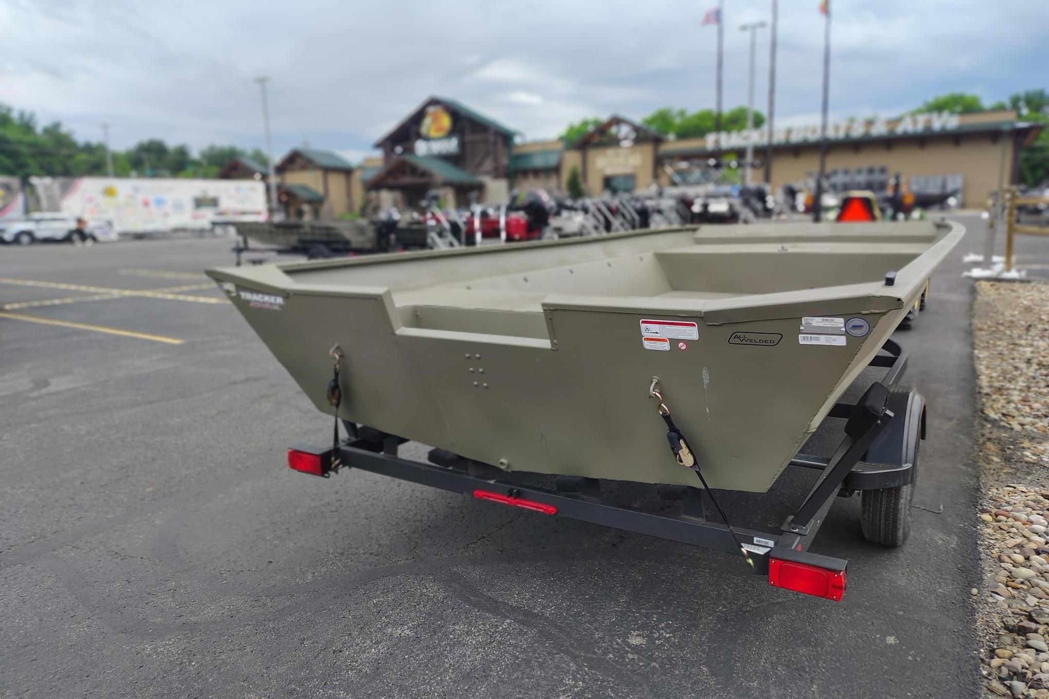 2026 Tracker Grizzly 2072 Utility boat on trailer in parking lot.