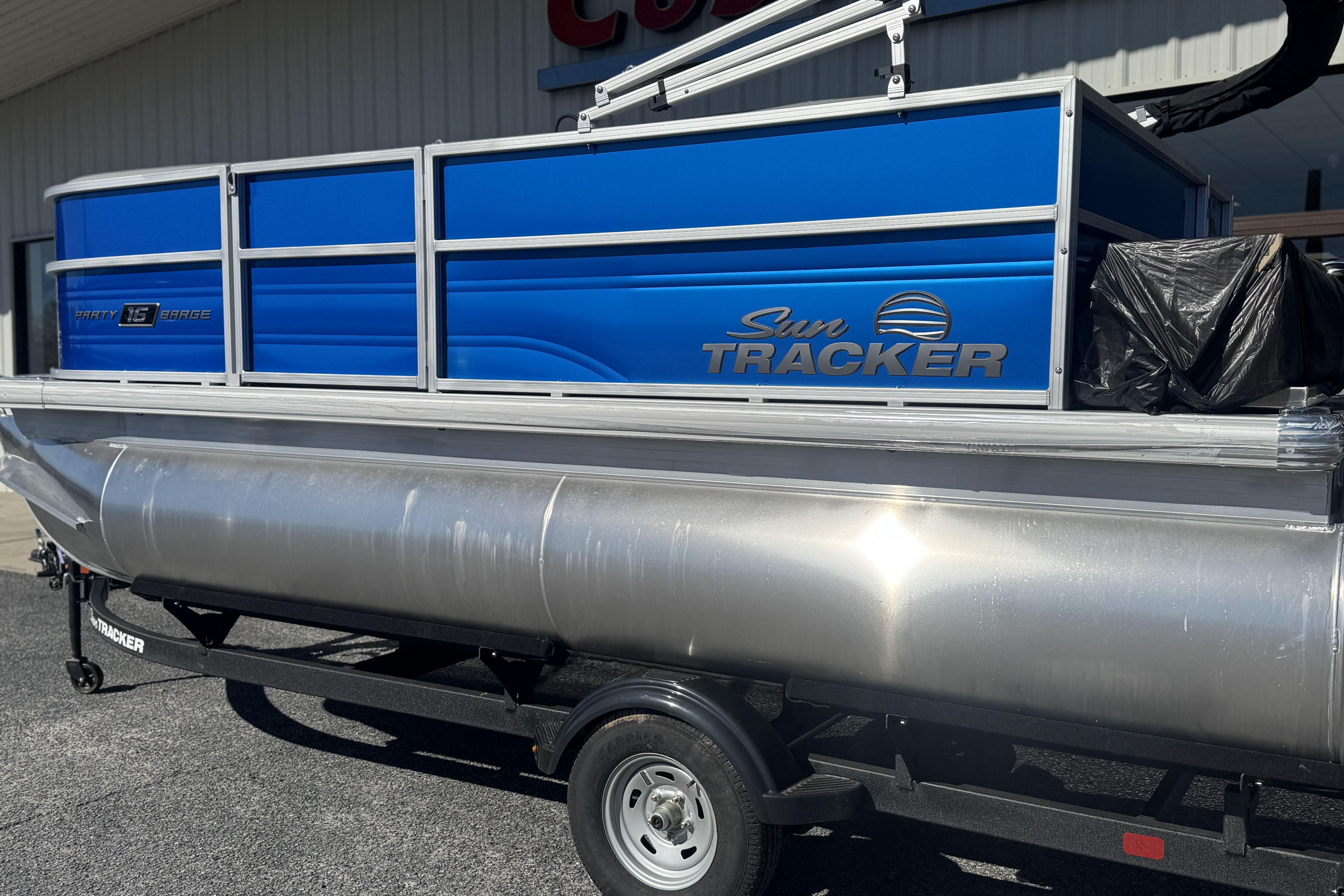 2026 Sun Tracker Party Barge 16 DLX pontoon boat with blue paneling.