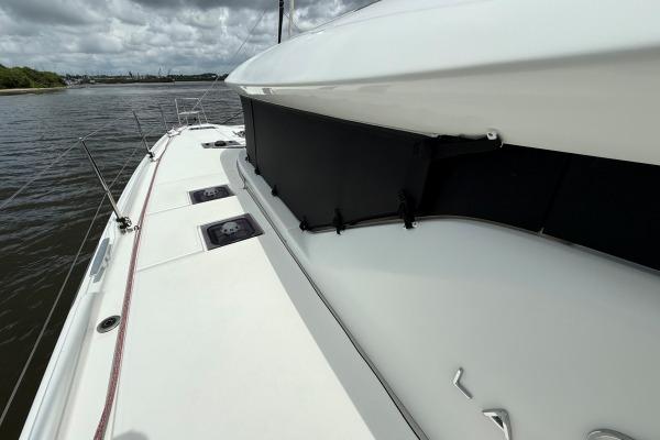 2023 Lagoon 46 catamaran deck view on a cloudy day.