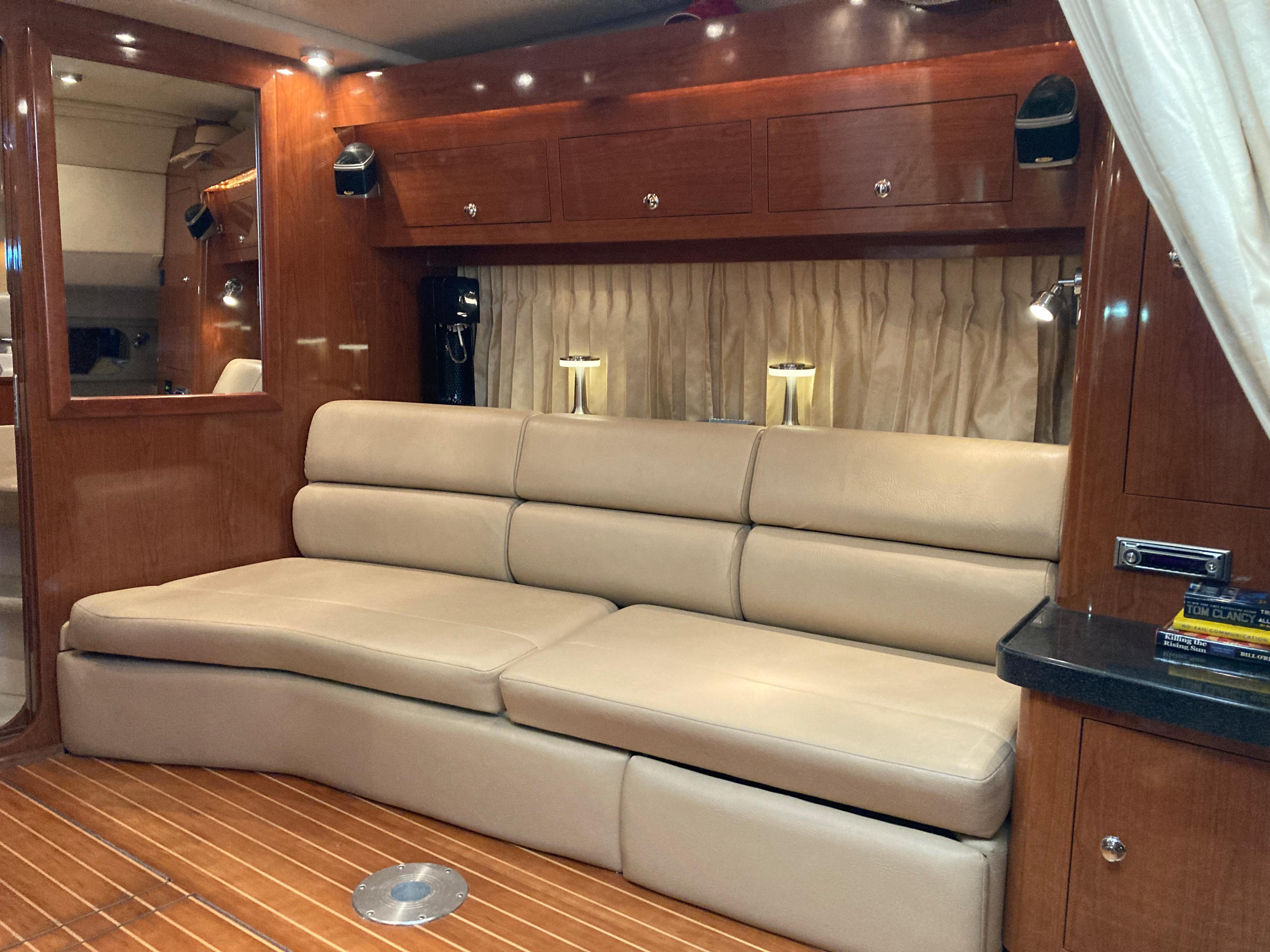 Luxurious interior of 2007 Regal 3760 Commodore yacht with beige leather seating.