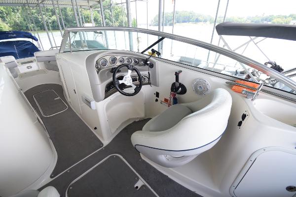 The cockpit of a 2010 Bryant 255 boat with a white seat and dashboard.