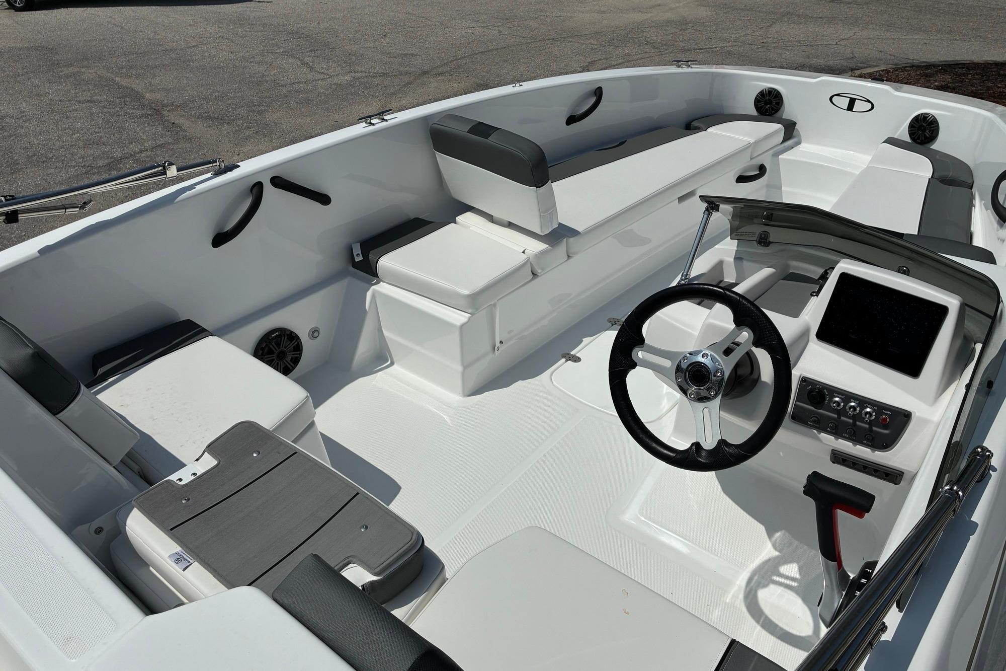 2026 Tahoe T18 boat interior with steering wheel, seating, and control panel.