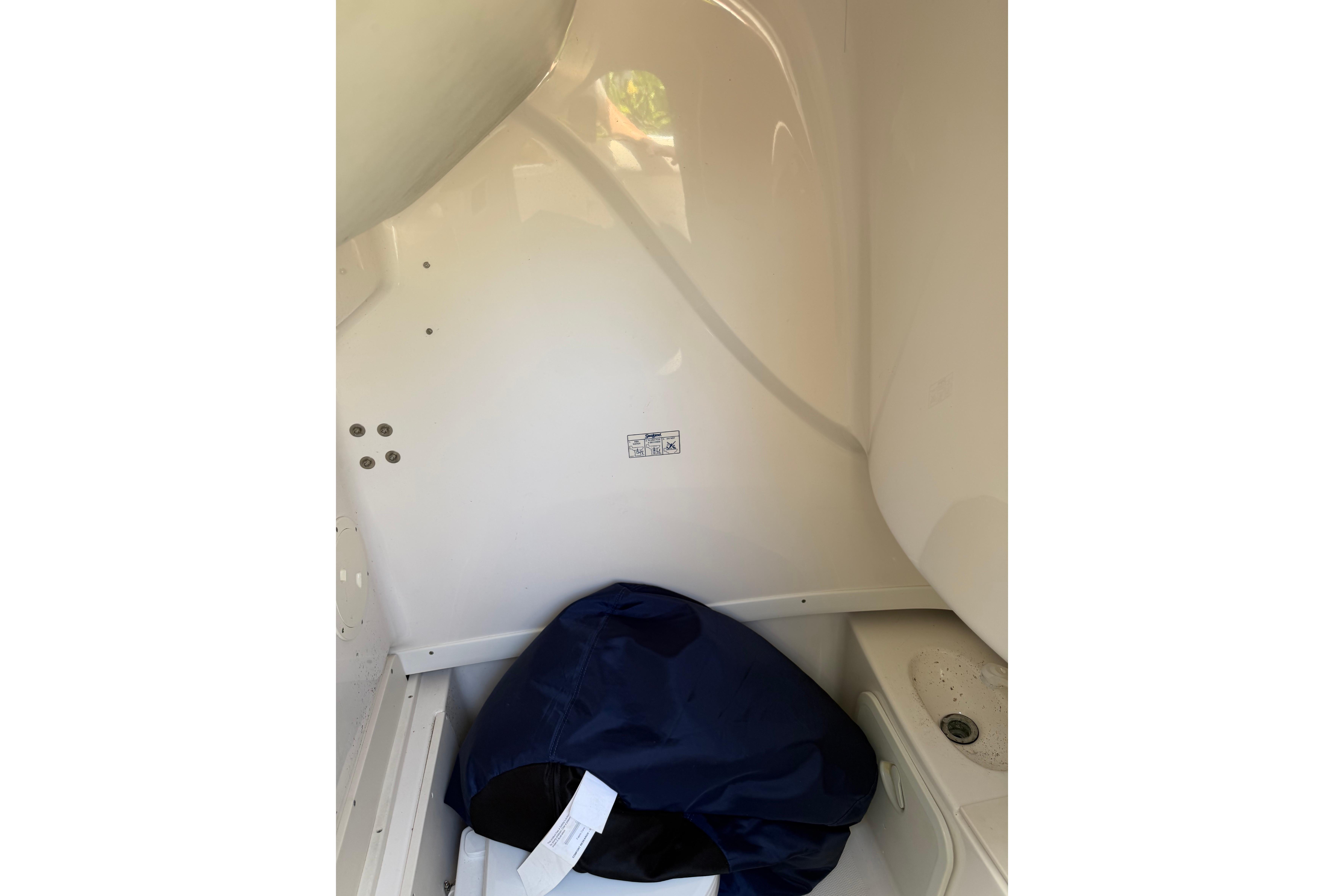 Interior of 2007 Robalo R260 Center Console boat with storage compartment.