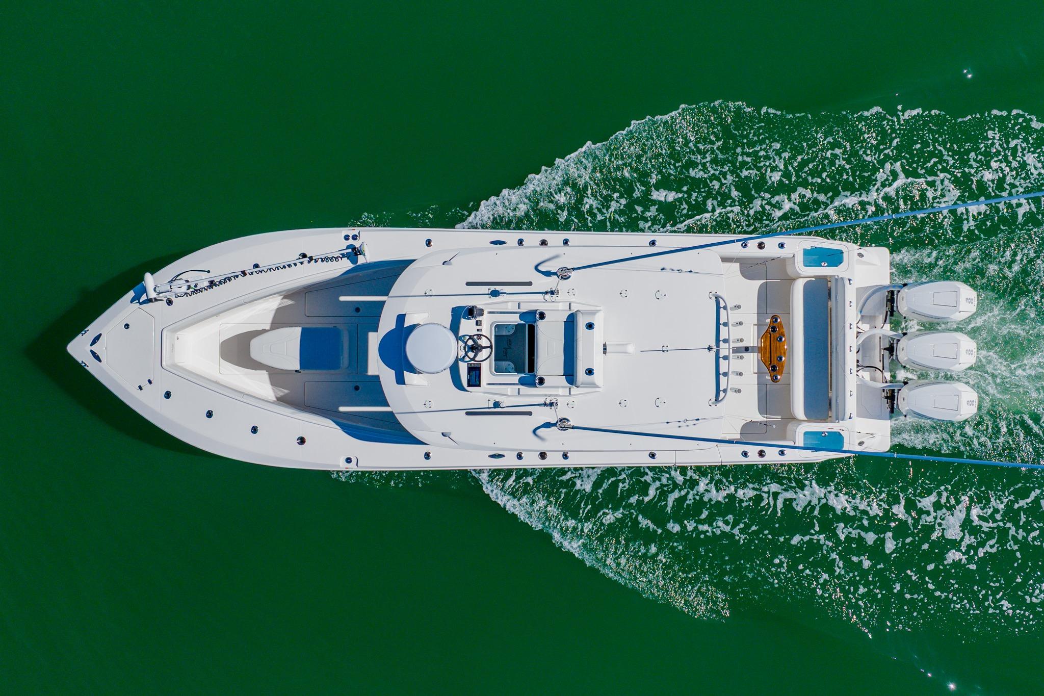 Aerial view of 2025 SeaVee 370Z boat cruising on green water.