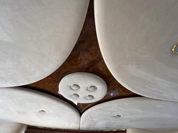 Luxurious interior ceiling of a 2009 Ovation 52 with elegant lighting fixtures.