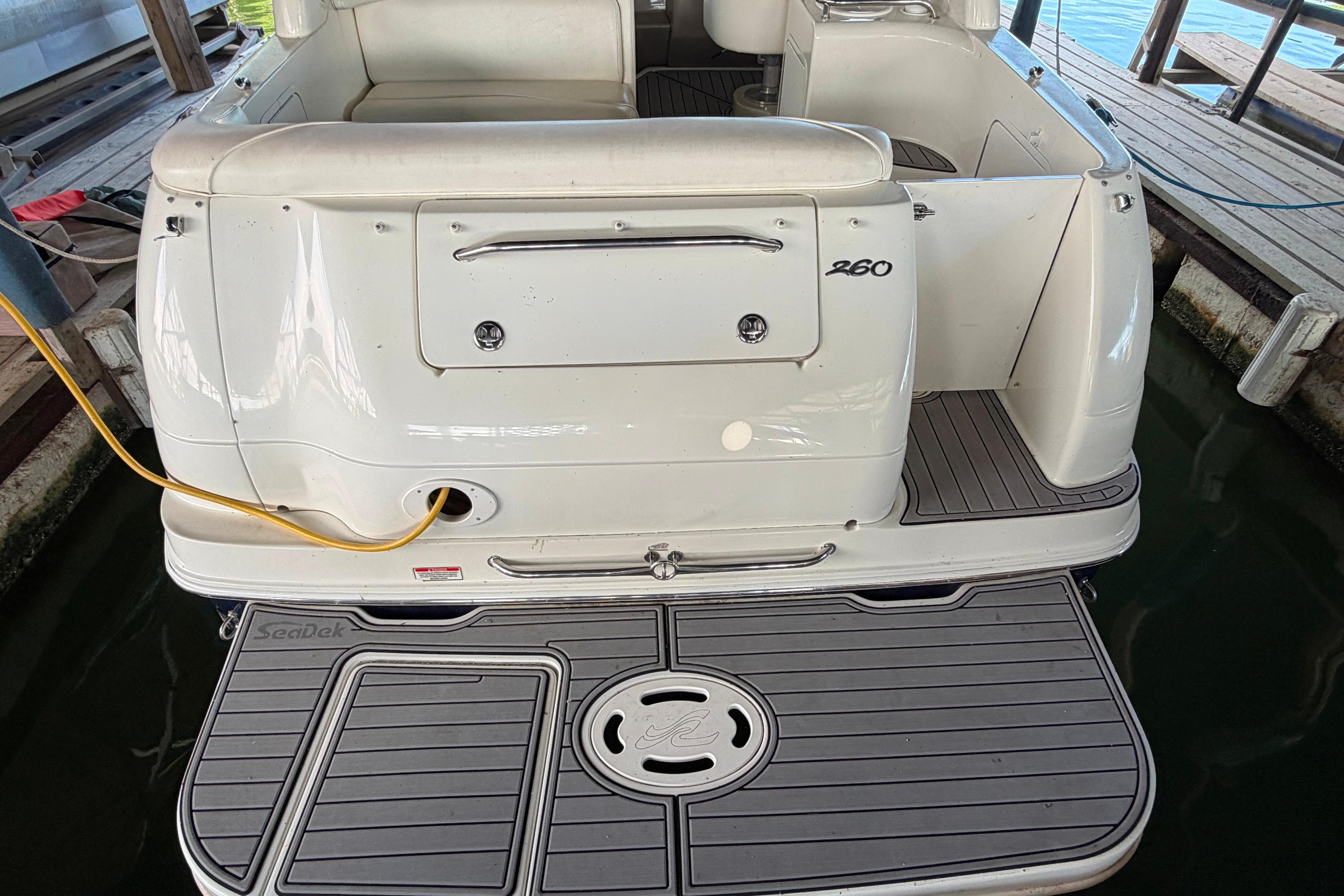 2004 Sea Ray Sundancer 260 boat docked, featuring a spacious swim platform and sleek design.