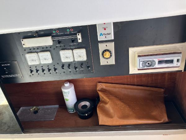 Control panel of 1985 Cruisers Yachts 338 Chateau Vee with gauges and storage.