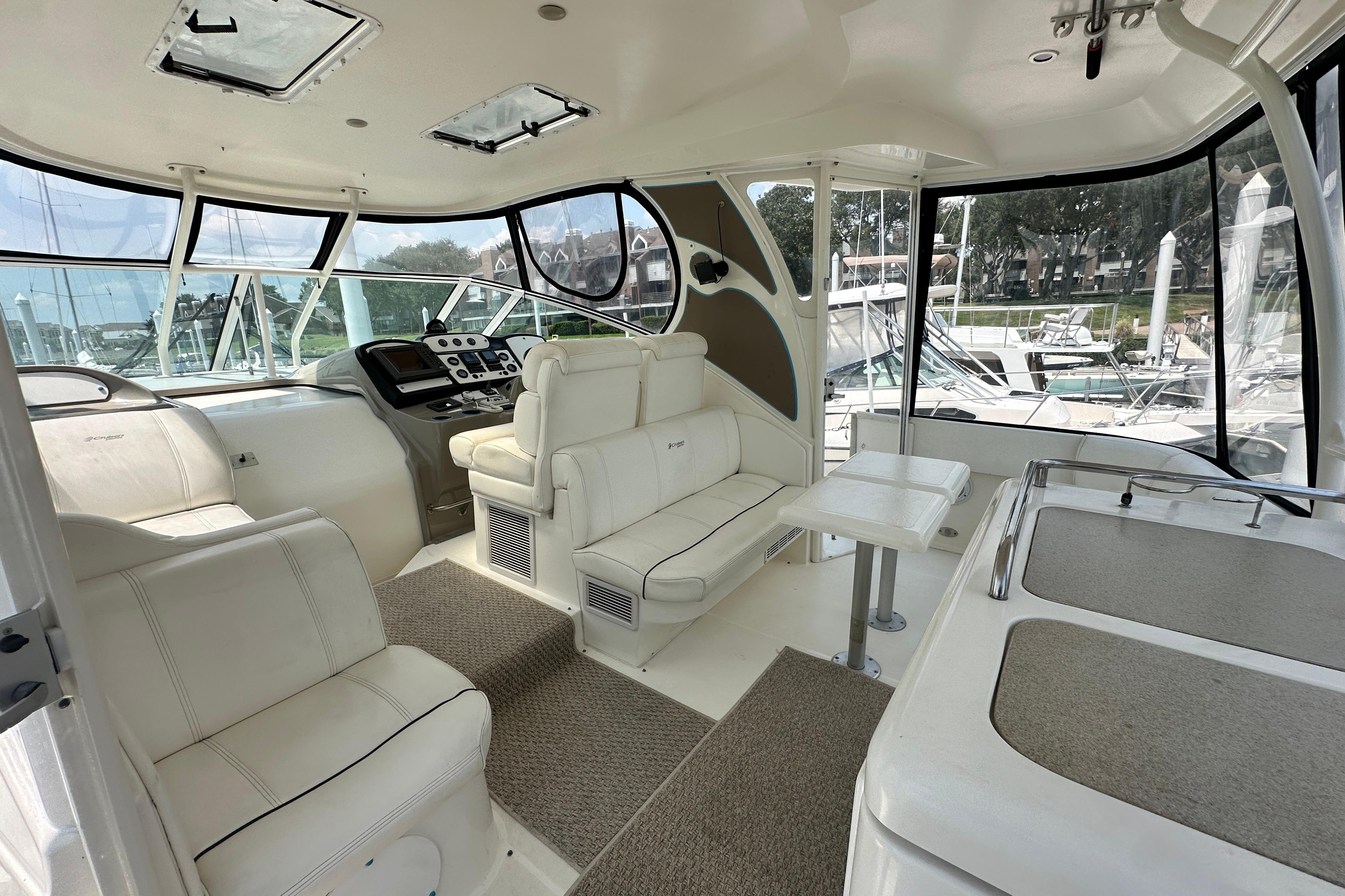 Luxurious interior of 2004 Cruisers Yachts 405 Express Motoryacht with plush seating and helm.