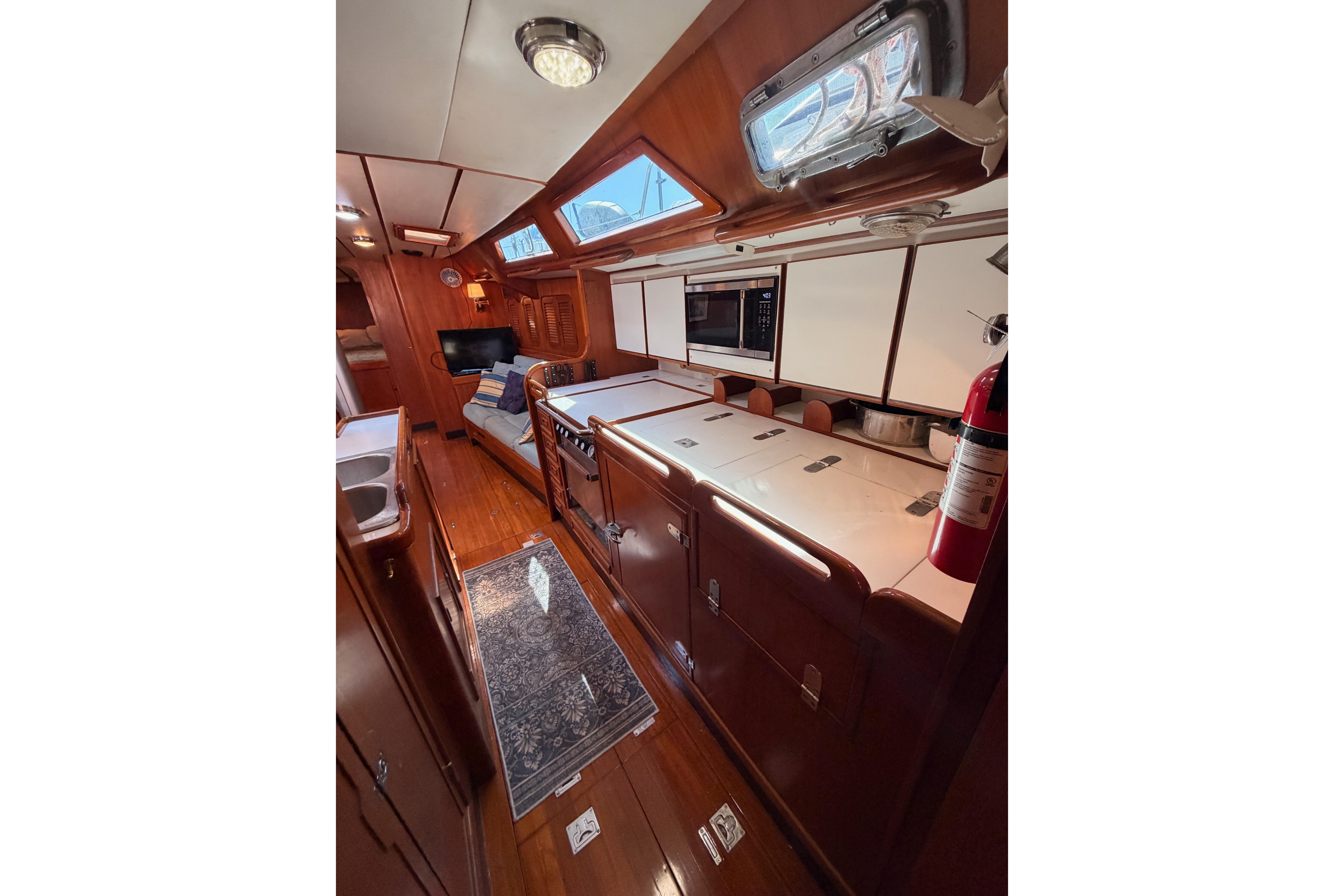 Interior of a 1991 Hylas 51 yacht with wood finishes and modern amenities.