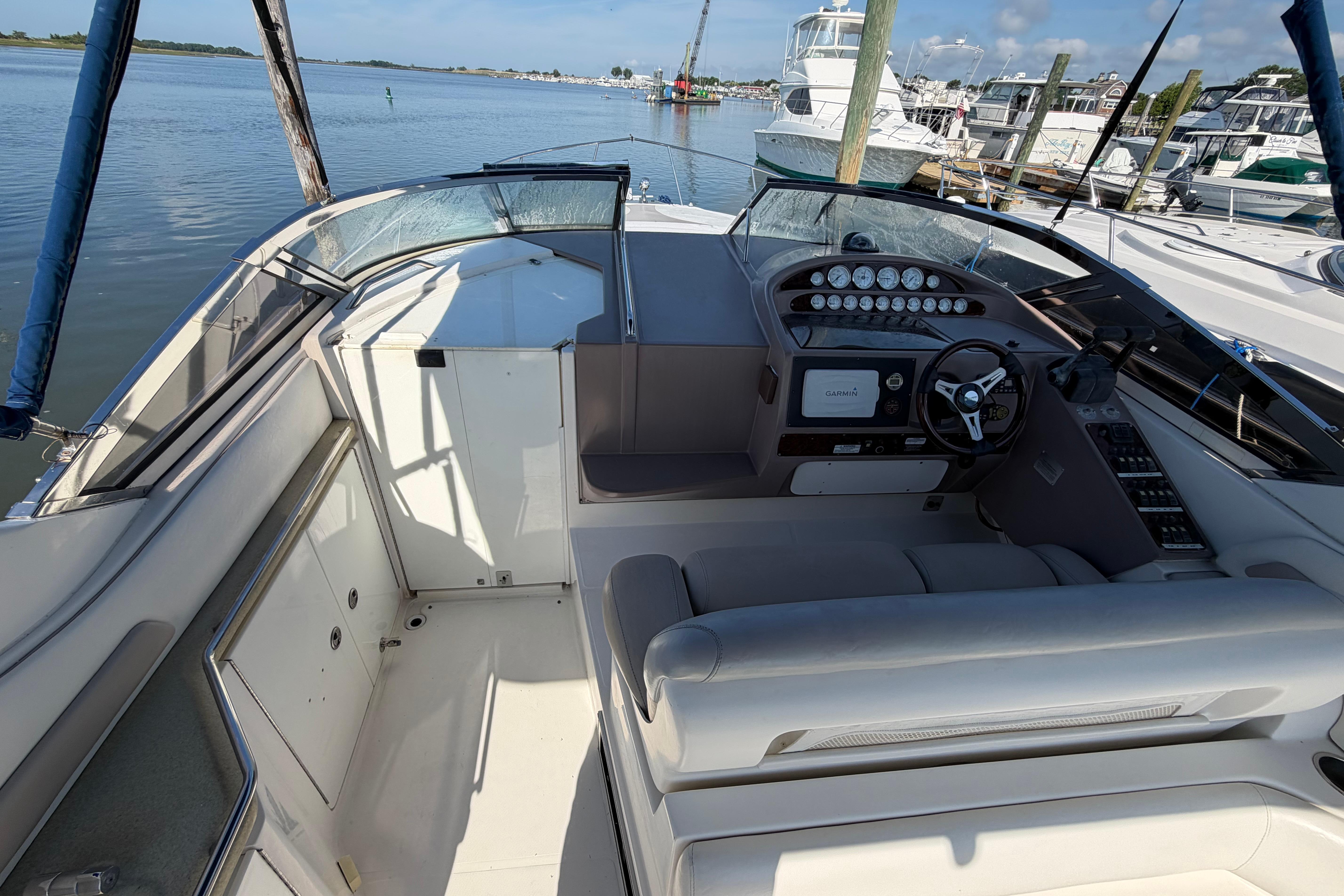 2003 Regal Commodore 3260 boat cockpit with steering wheel and navigation system.